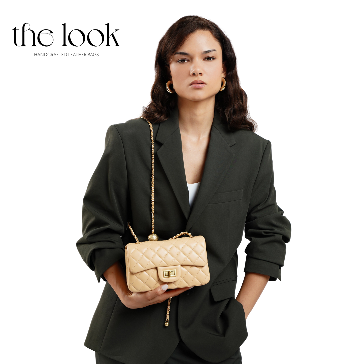 Woman holding a beige quilted handbag with 'the look' branding. | The Look Officiel