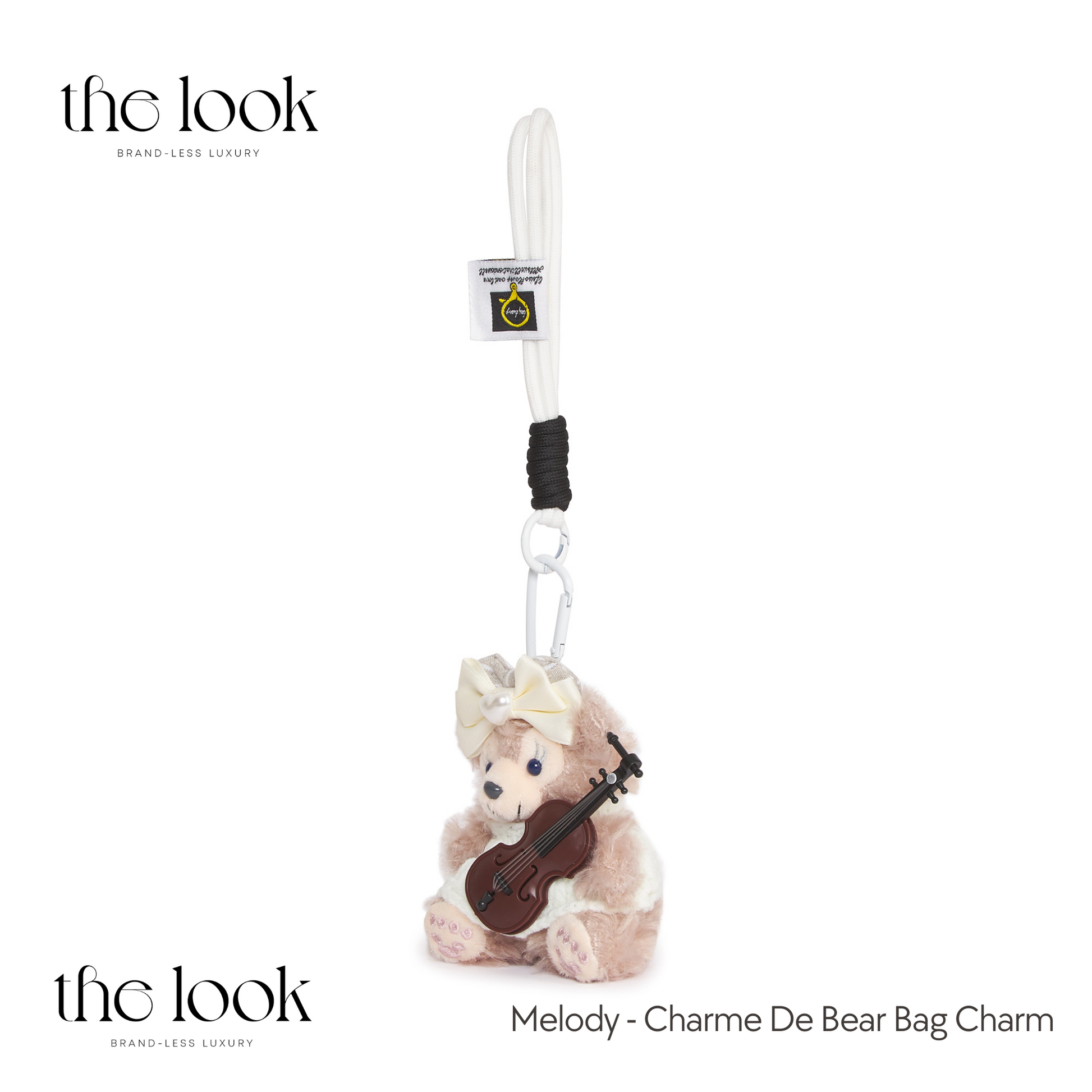 Charm de Bear bag charm with a bear holding a violin on a white background, branded 'the look'. | The Look Officiel