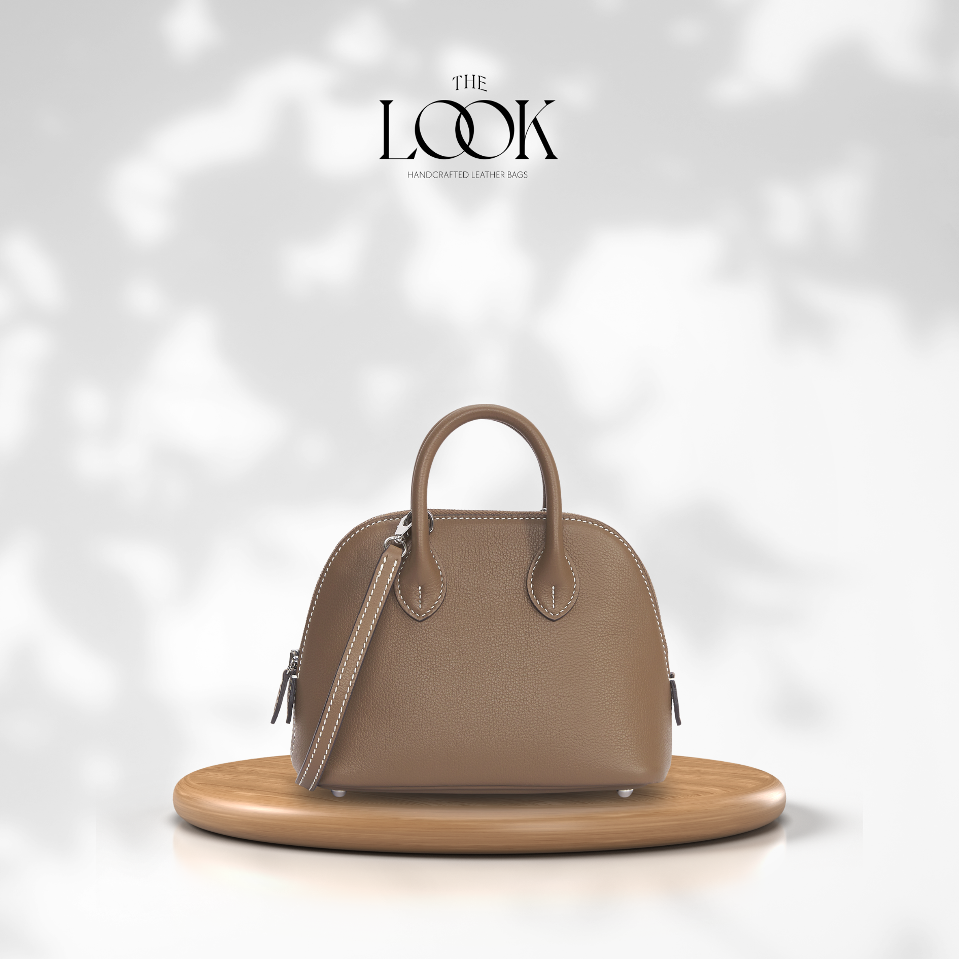 Brown handbag on a wooden stand with a soft white background, featuring 'The Look' brand. | The Look Officiel