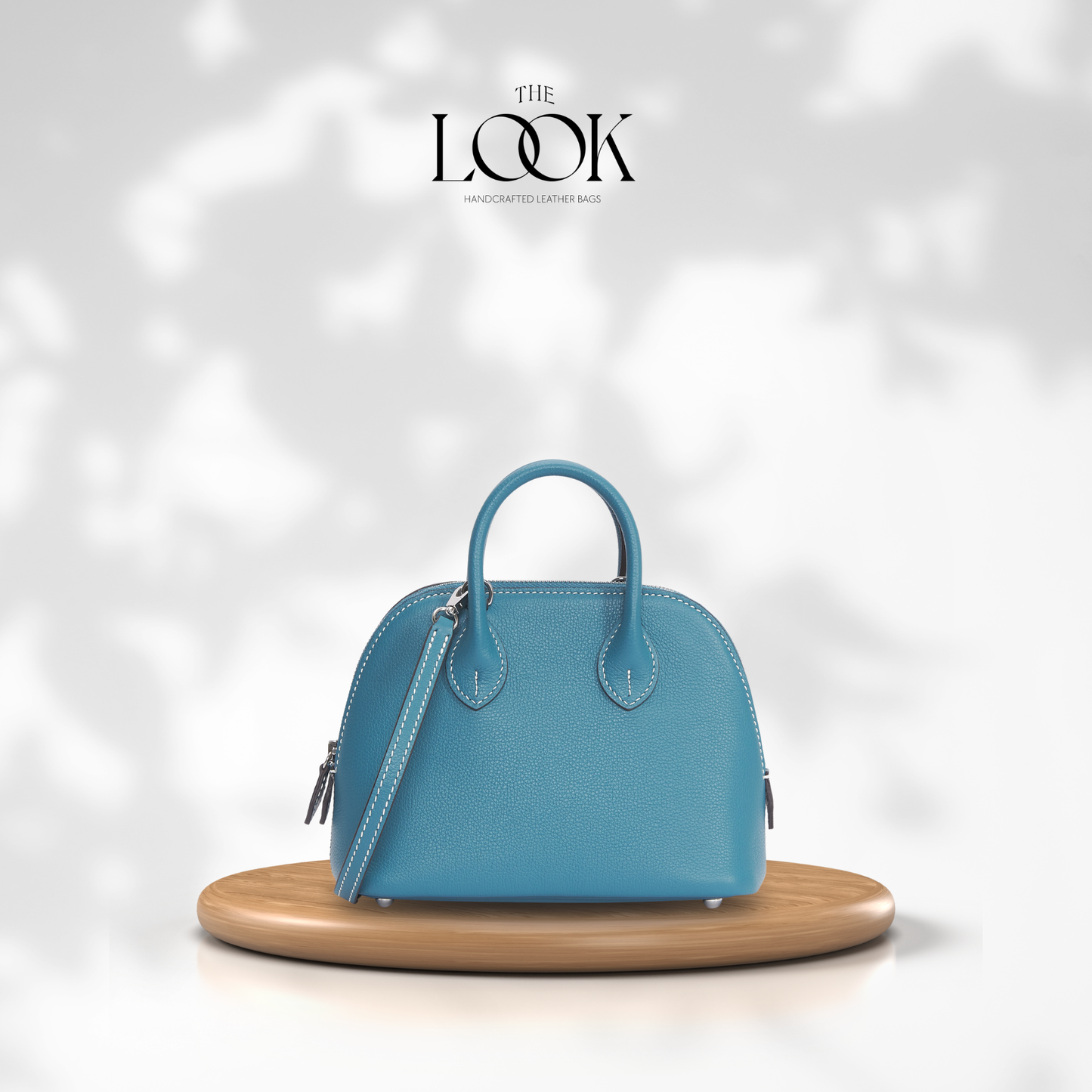 Blue handbag on a wooden stand with 'The Look' branding in the background| The Look Officiel
