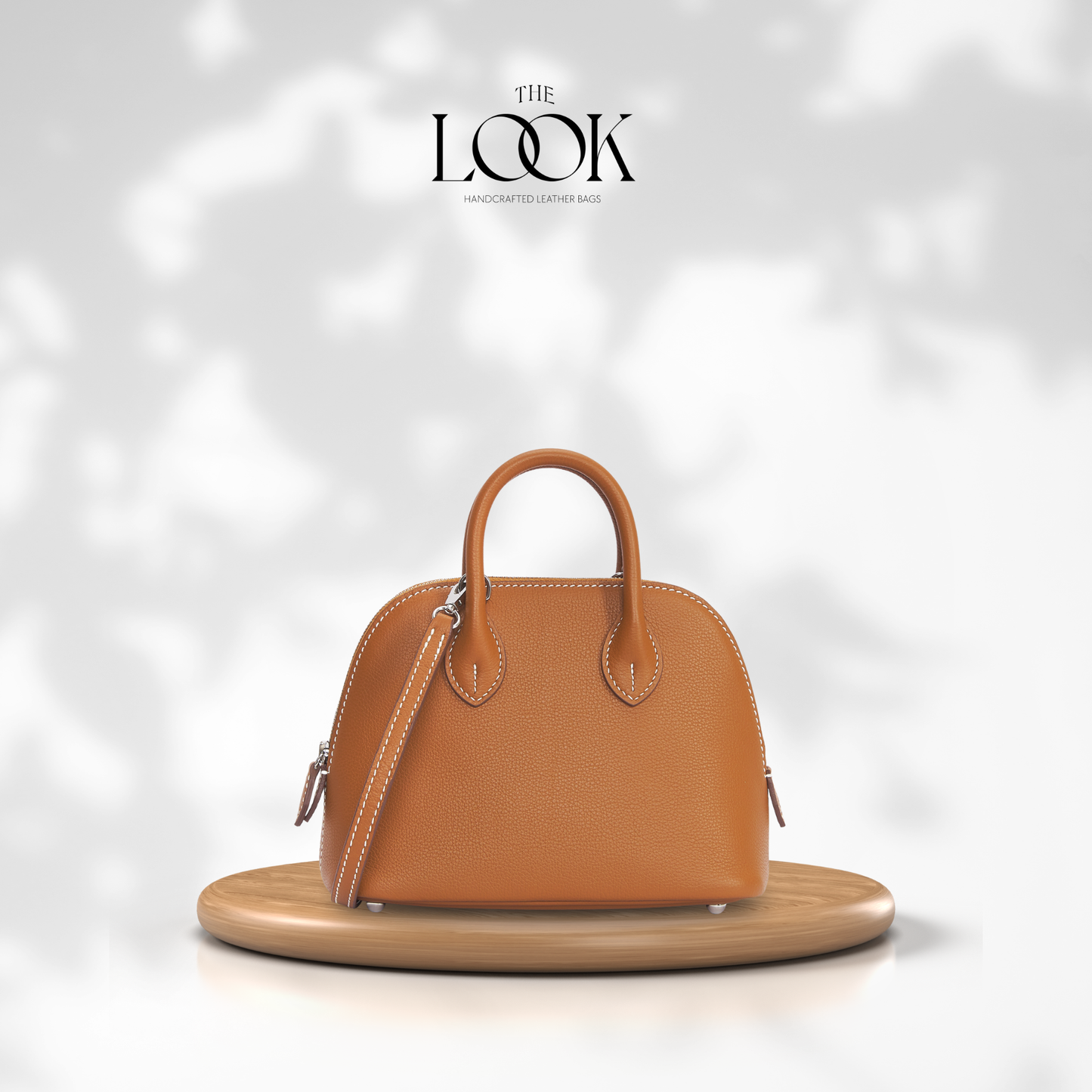 Brown handbag on a wooden stand with a soft white background and 'The Look' brand logo. | The Look Officiel
