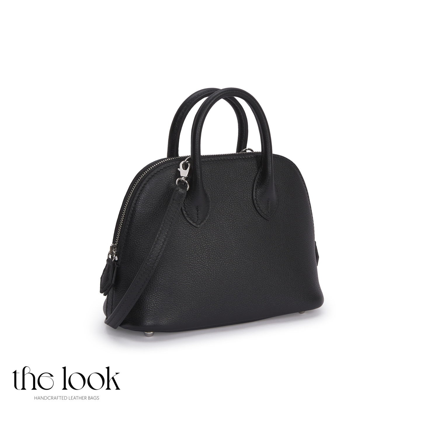 Black handbag with a shoulder strap on a white background, featuring 'the look' brand.| The Look Officiel