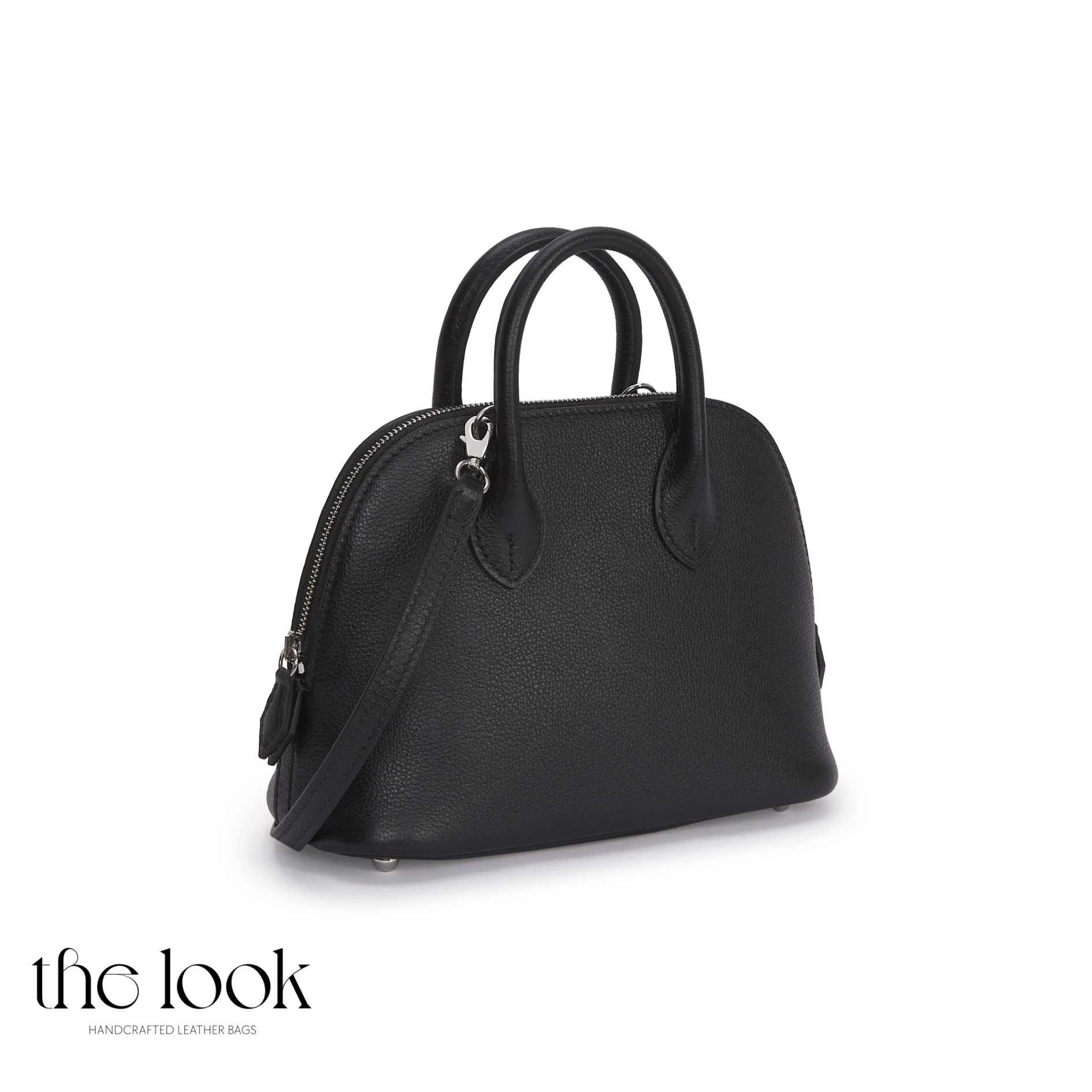 Black handbag with a shoulder strap on a white background, featuring 'the look' brand.| The Look Officiel