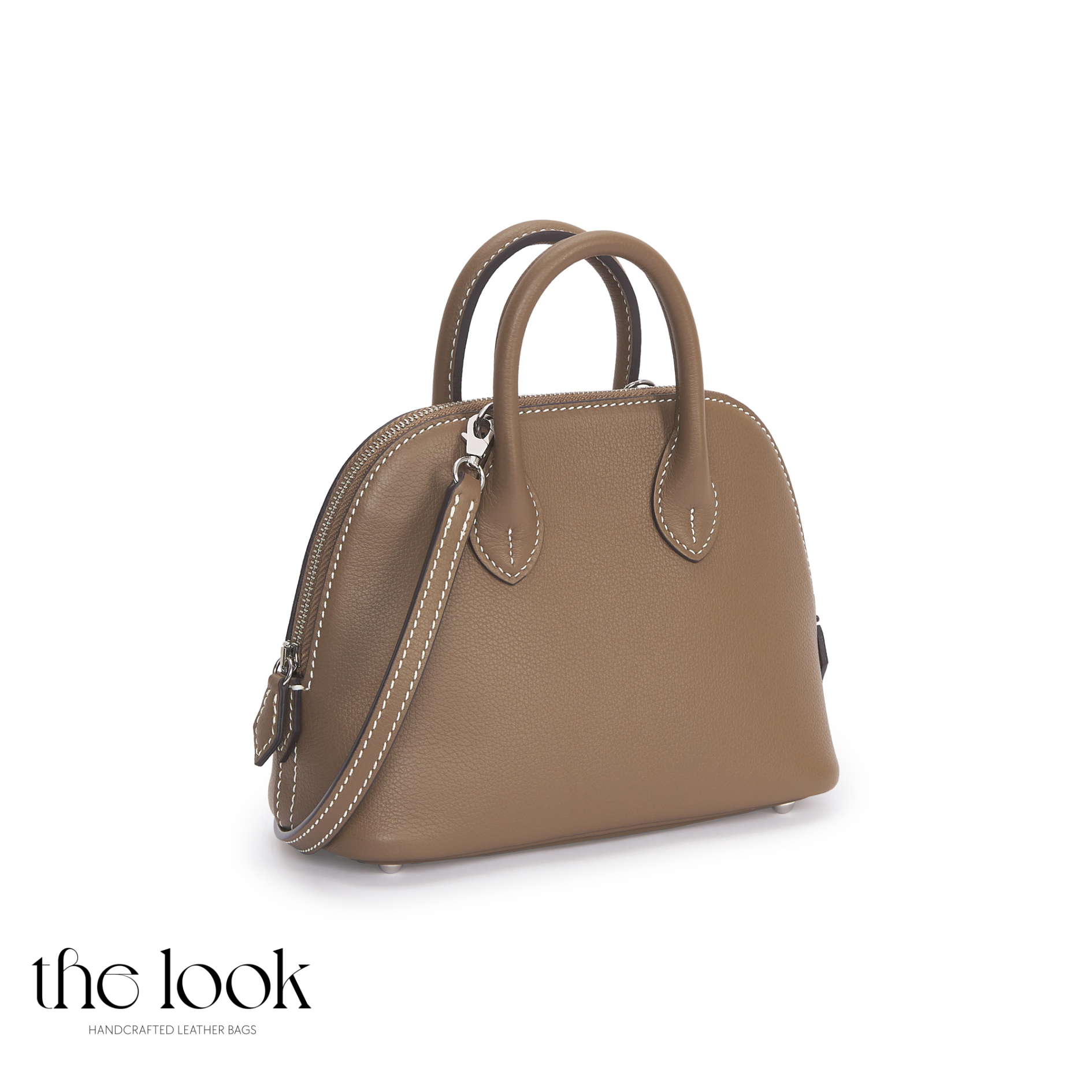 Brown handbag on a white background with 'the look' branding. | The Look Officiel