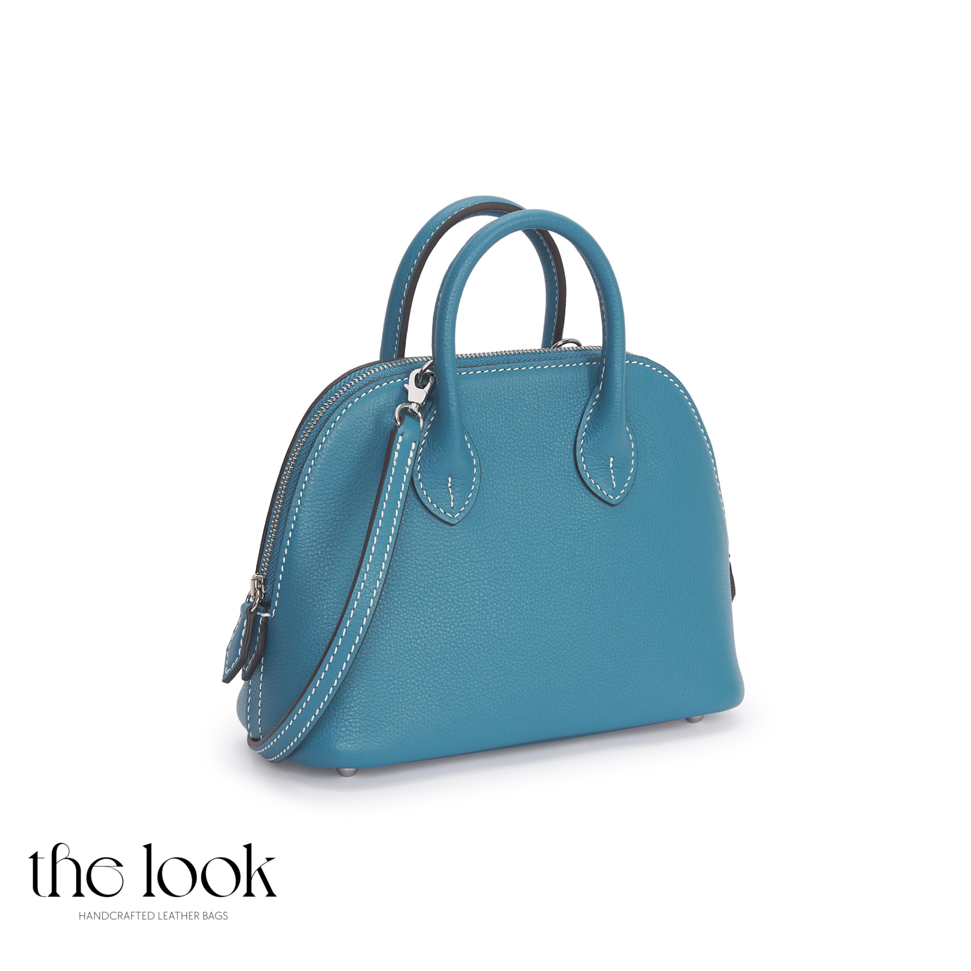 Blue handbag on a white background with 'the look' branding.| The Look Officiel