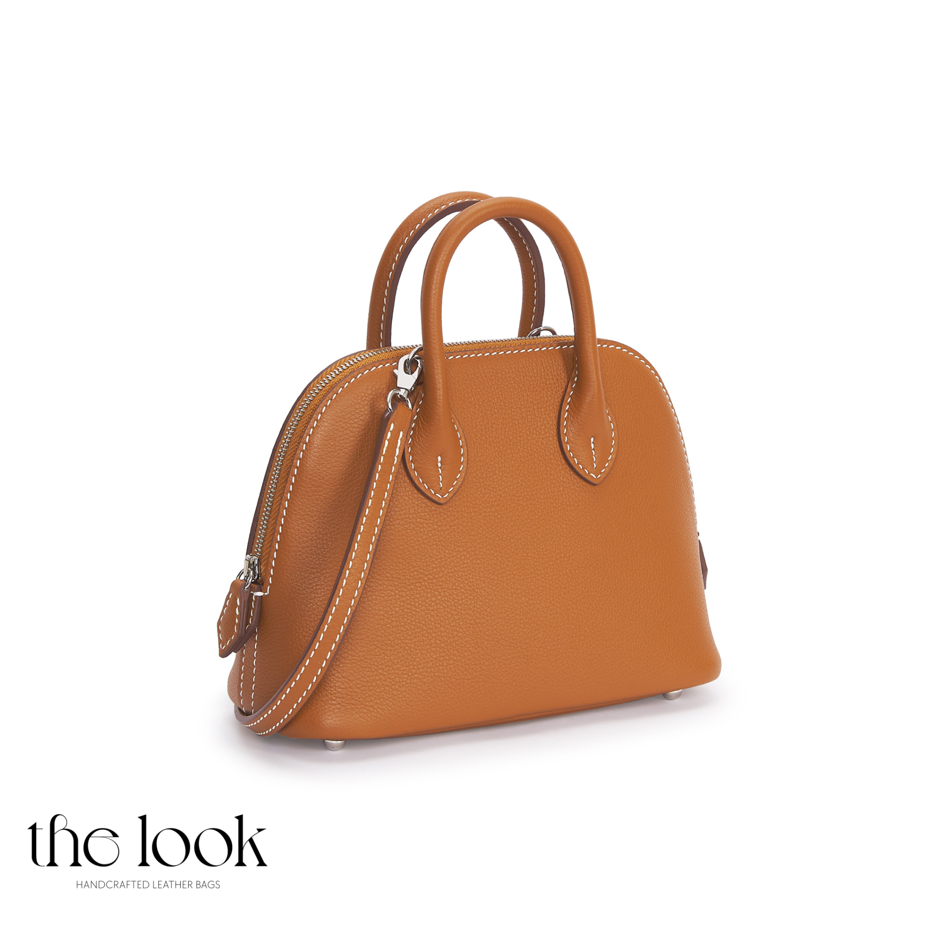 Brown handbag with a strap on a white background, featuring 'the look' brand. | The Look Officiel