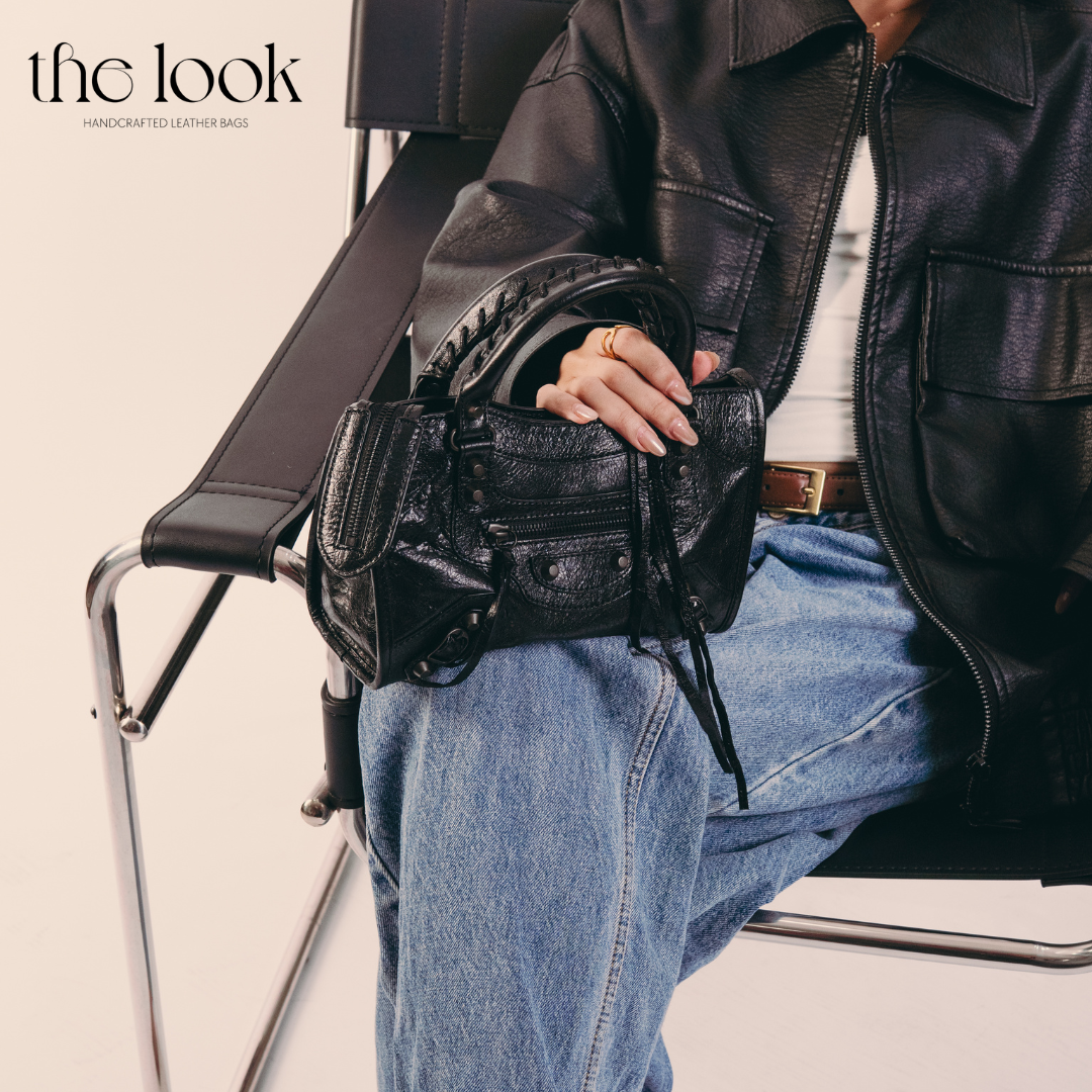 Model holding Biker Satchel Small Gunmetal hardware Front View Goat skin 