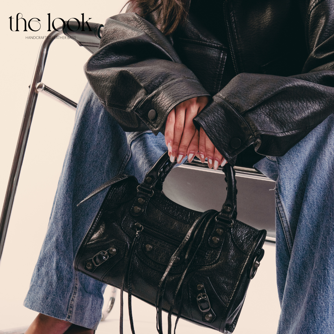 Model holding Biker Satchel Small Gunmetal hardware Front View Goat skin 