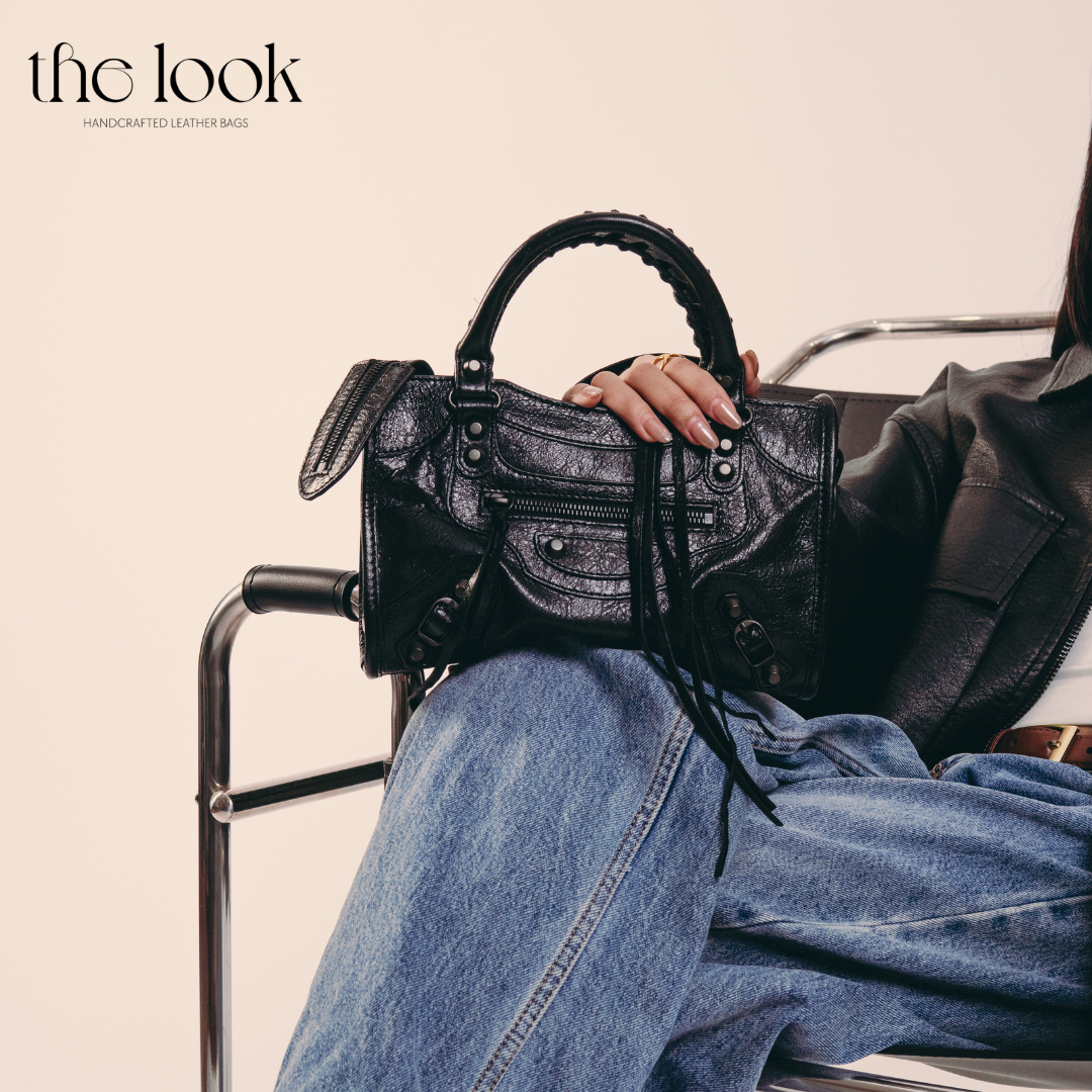 Model holding Biker Satchel Small Gunmetal hardware Front View Goat skin 