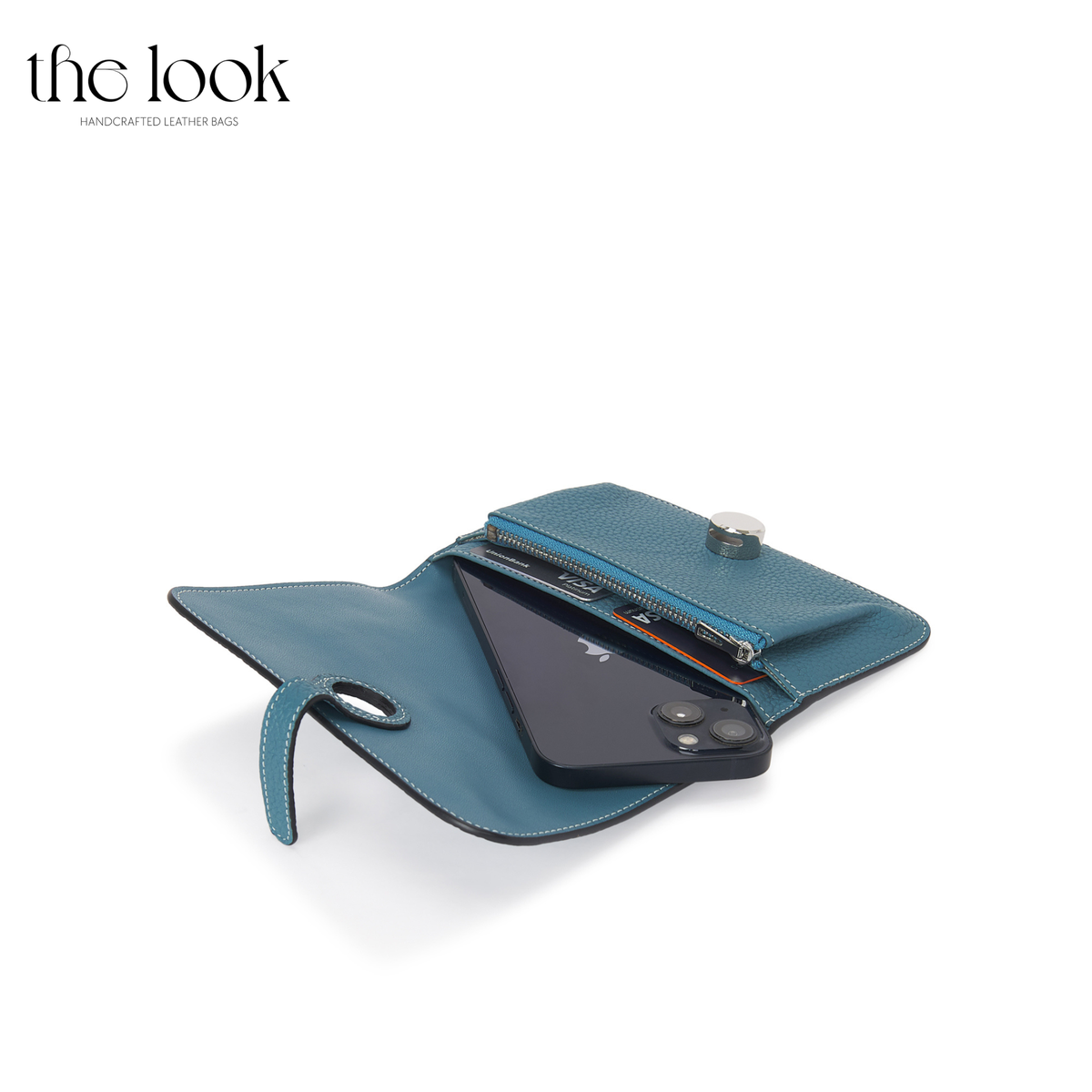 Cleo Small Wallet in Denim Blue top-grain pebbled calfskin leather with stainless steel silver hardware, opened with cards and phone shown inside