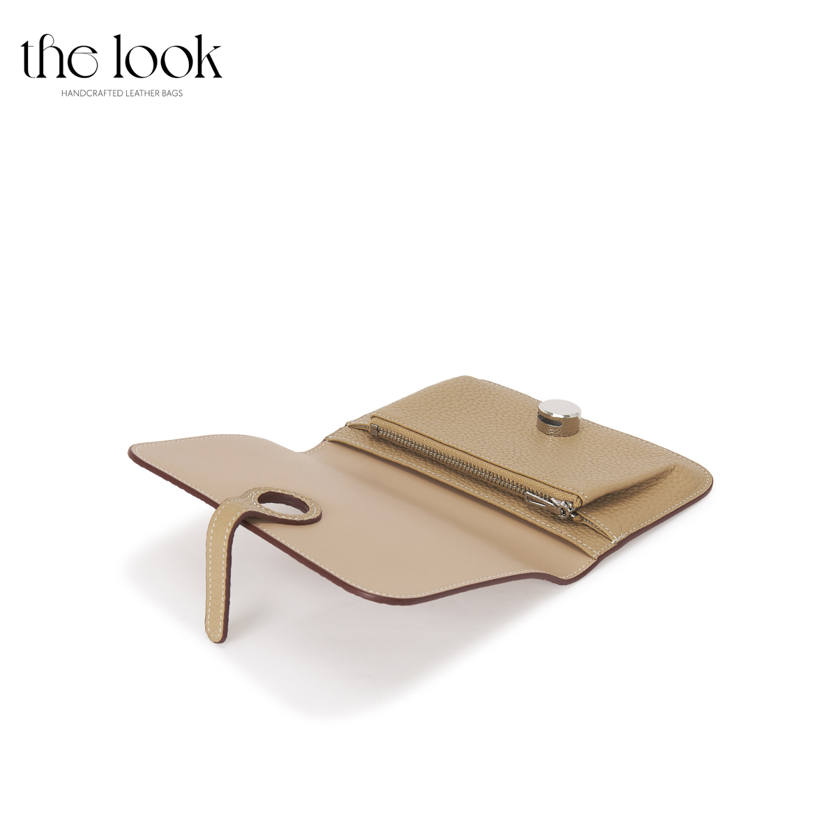 Cleo Small Wallet in Biscuit top-grain pebbled calfskin leather with stainless steel silver hardware, opened at an angle showing zipped coin compartment