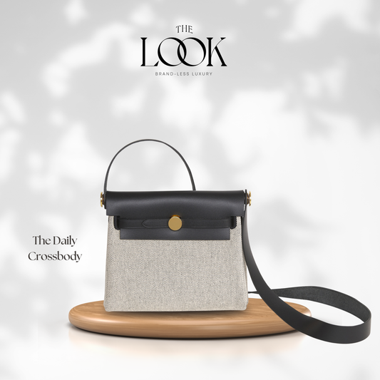 Gray crossbody bag with black handle and strap on a white background, featuring 'The Look' brand. | The Look Officiel