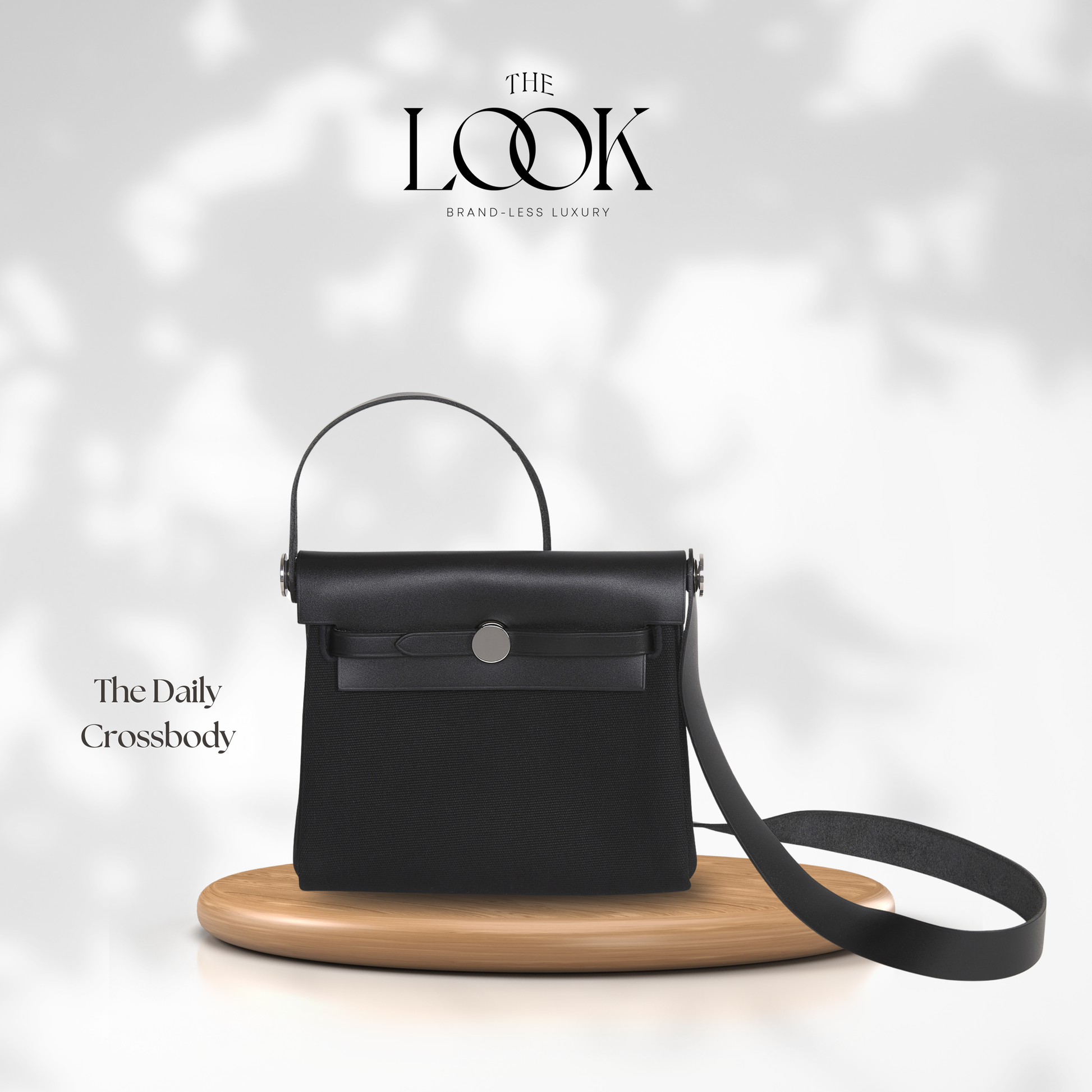 Black crossbody bag on a wooden stand with 'The Look' branding in the background | The Look Officiel