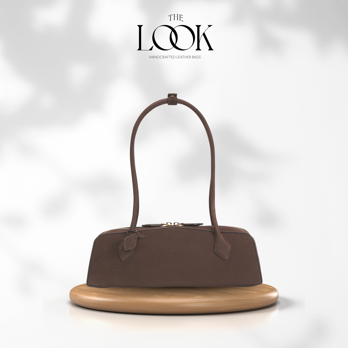 Brown handbag on a wooden stand with 'The Look' branding on a light gray background | The Look Officiel