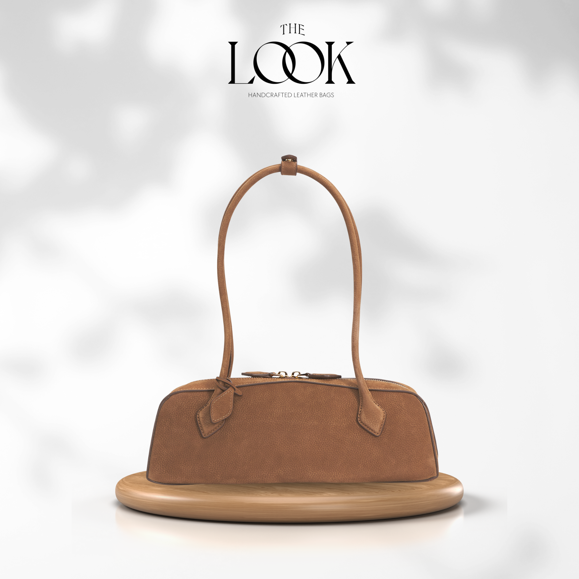 Brown handbag on a white platform with 'The Look' branding. | The Look Officiel