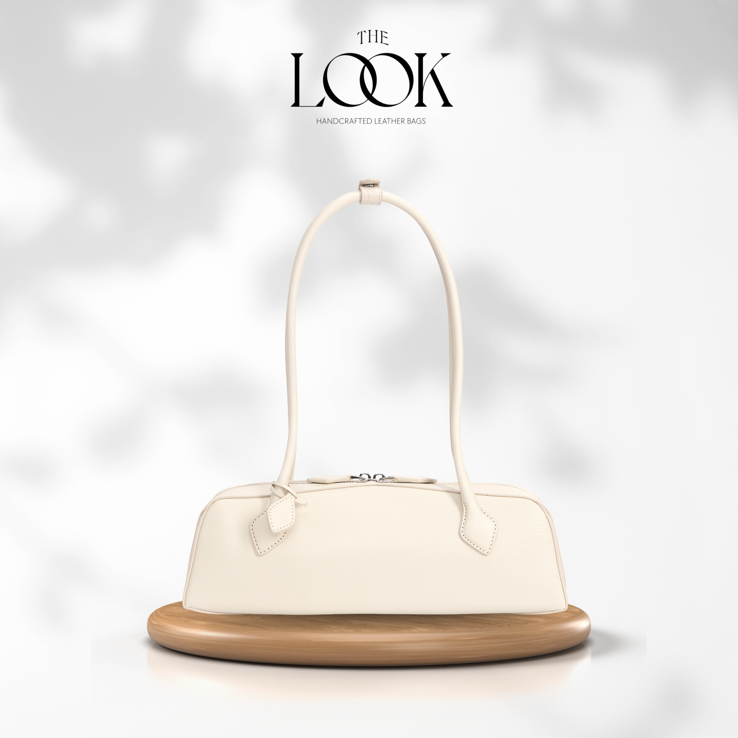 White handbag on a wooden stand with 'The Look' branding on a light gray background | The Look Officiel