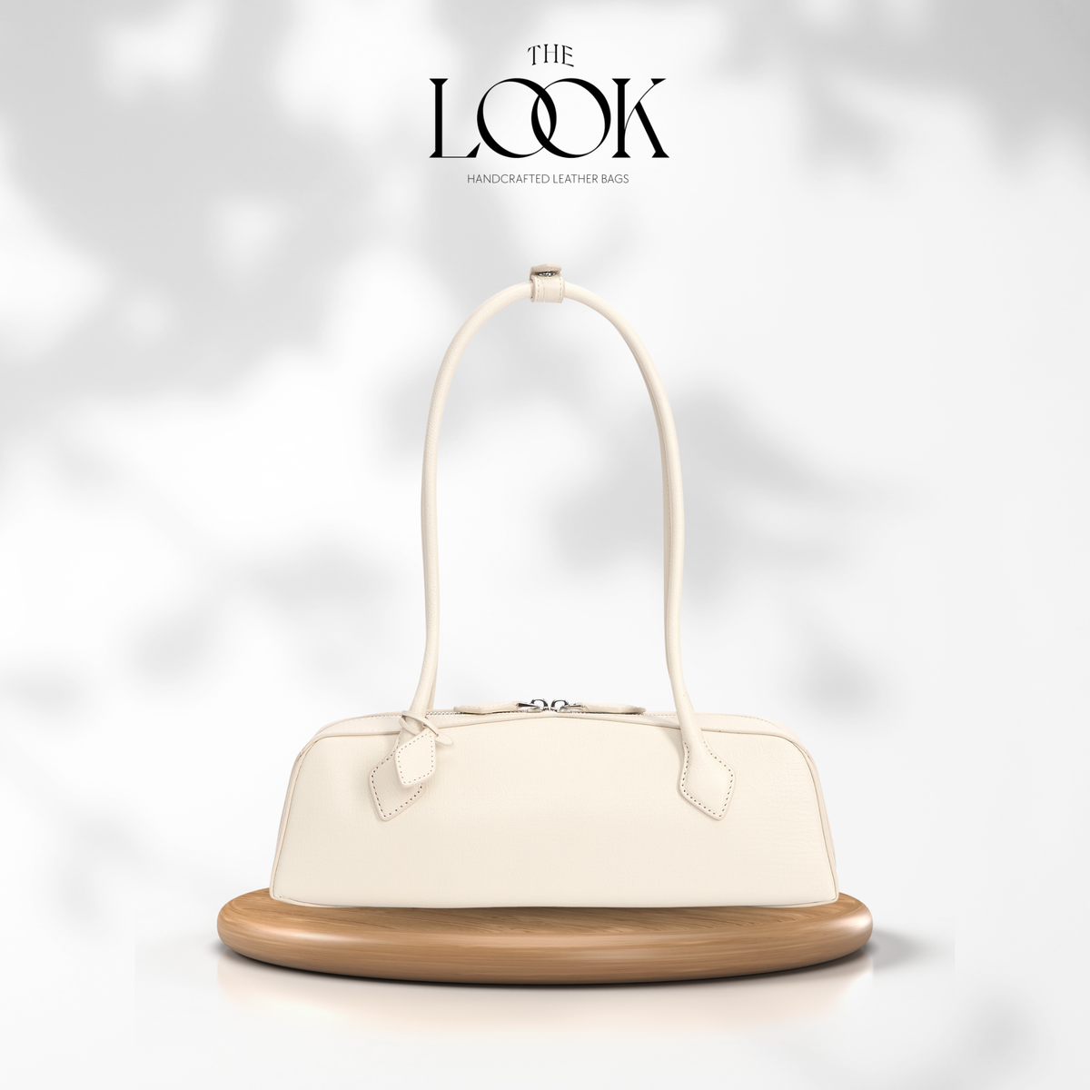White handbag on a wooden stand with 'The Look' branding on a light gray background | The Look Officiel