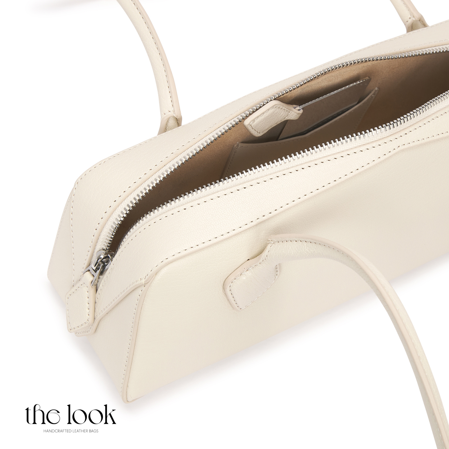 Beige handbag with open top on a white background | The Look Officiel