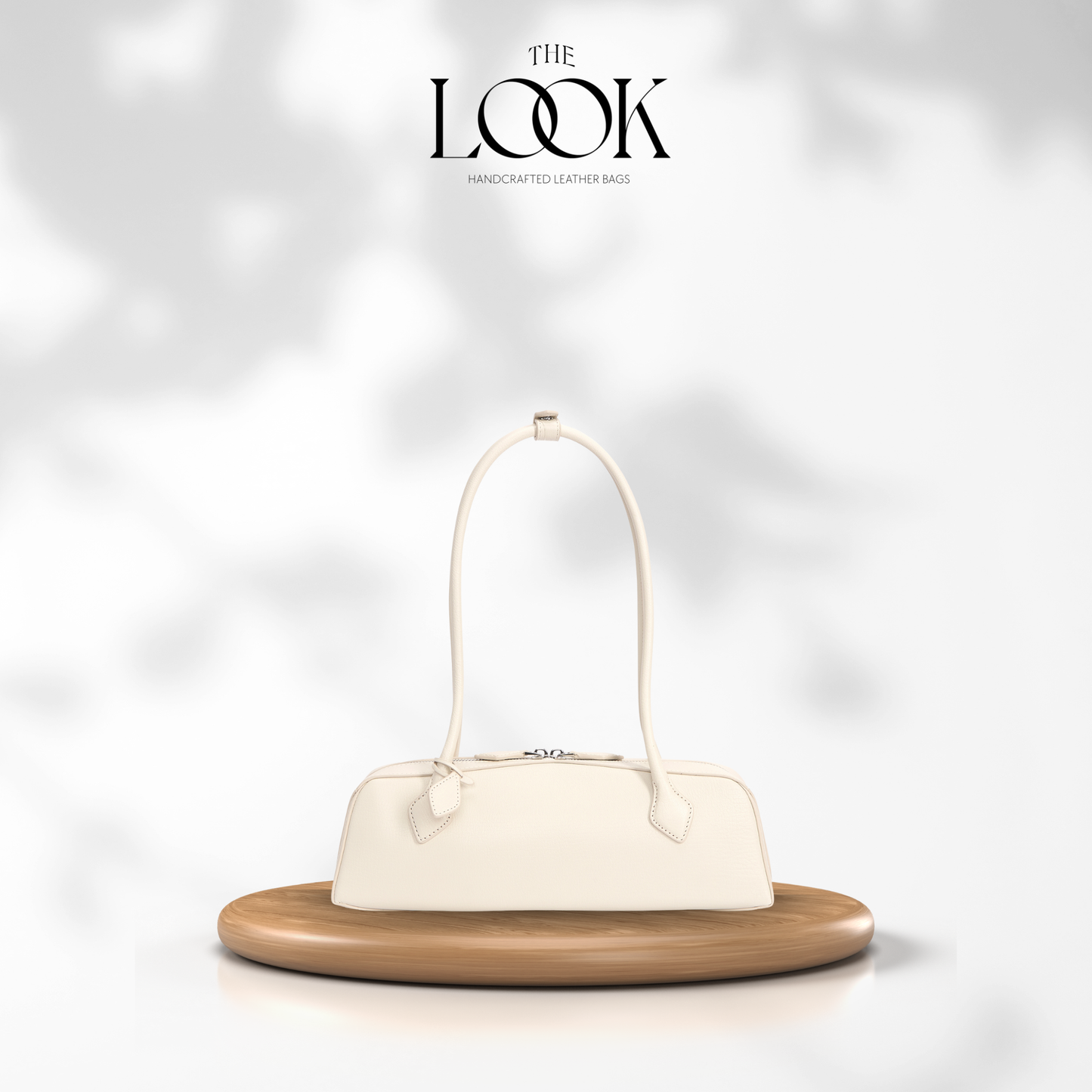 White handbag on a wooden stand with 'The Look' brand logo in the corner. | The Look Officiel