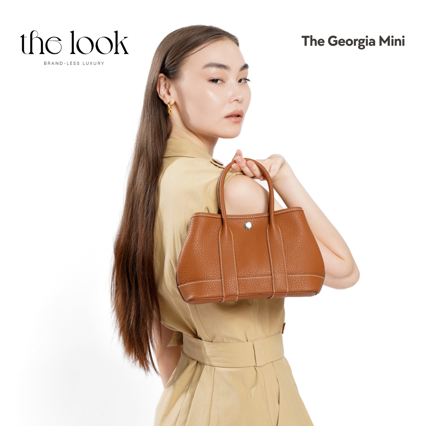Woman holding a brown handbag with 'the look' branding on a white background | The Look Officiel