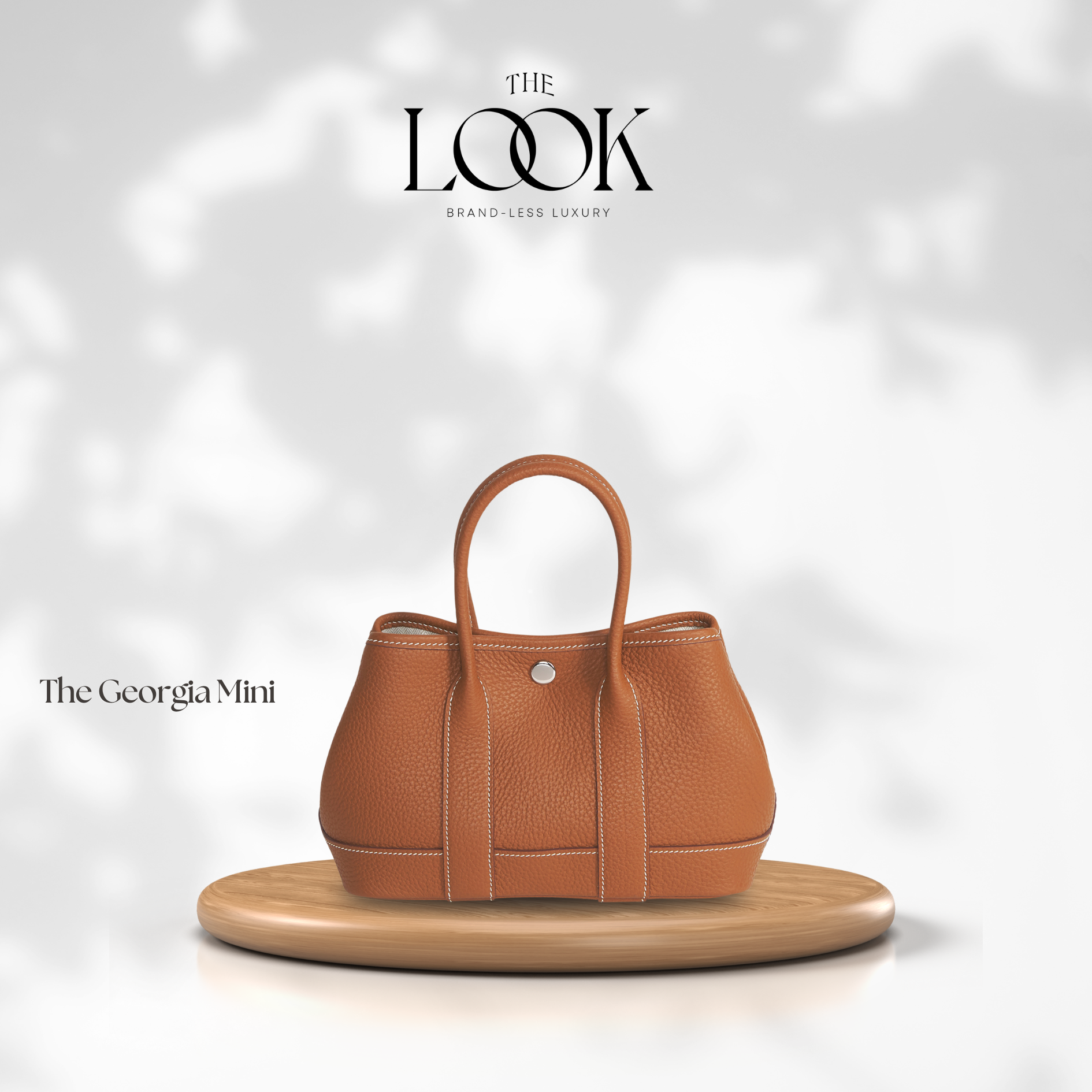 Brown handbag on a wooden stand with 'The Look' branding on a light gray background | The Look Officiel