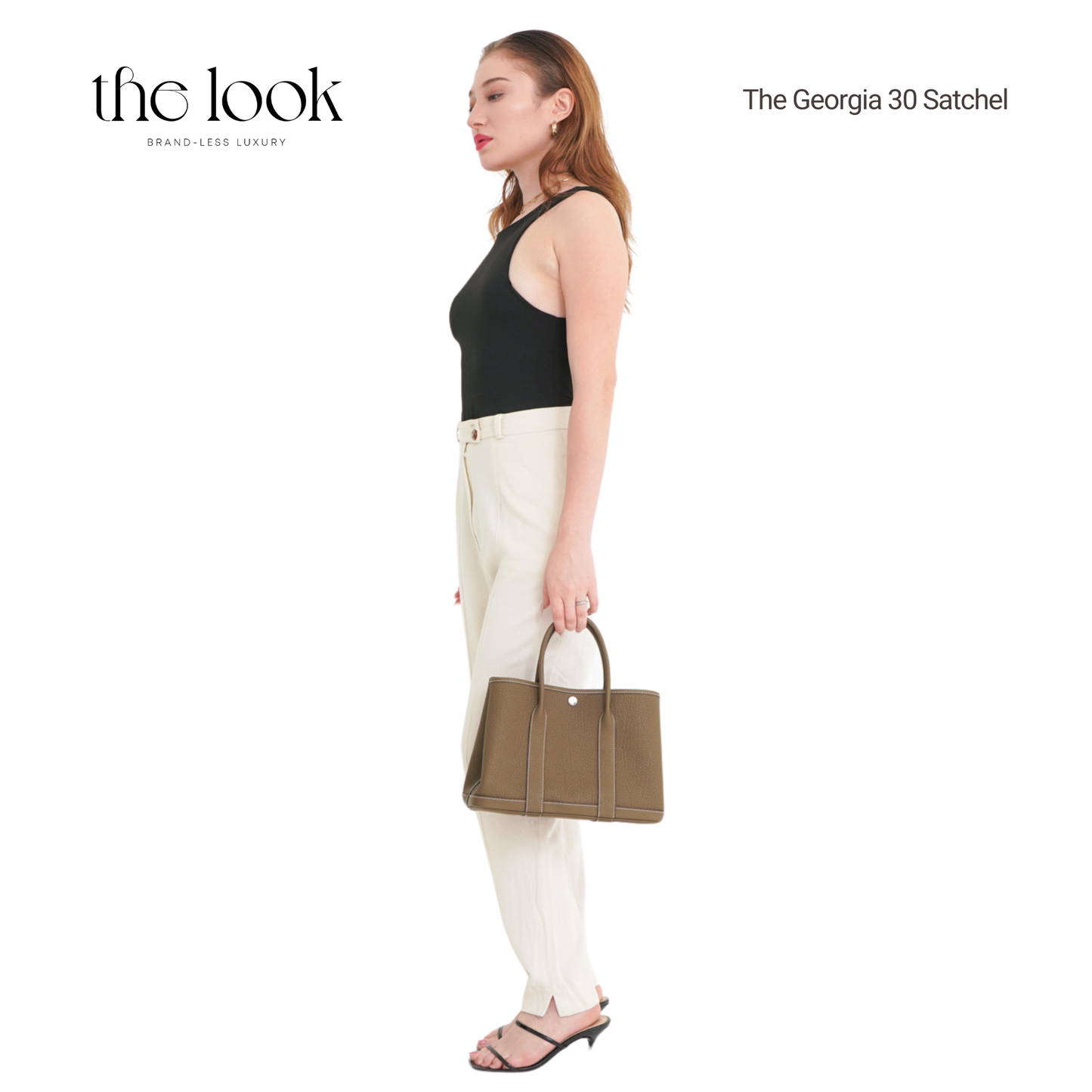 Woman holding a brown satchel with 'the look' branding on a white background | The Look Officiel