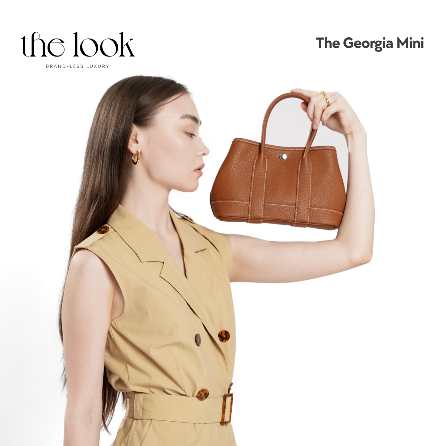 Woman holding a brown handbag with 'the look' branding on a white background | The Look Officiel