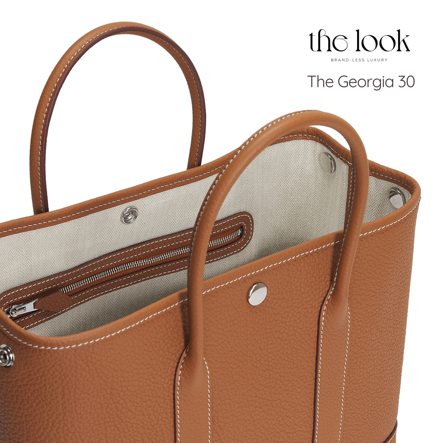 Brown handbag with visible stitching and interior lining, branded 'the look'. | The Look Officiel