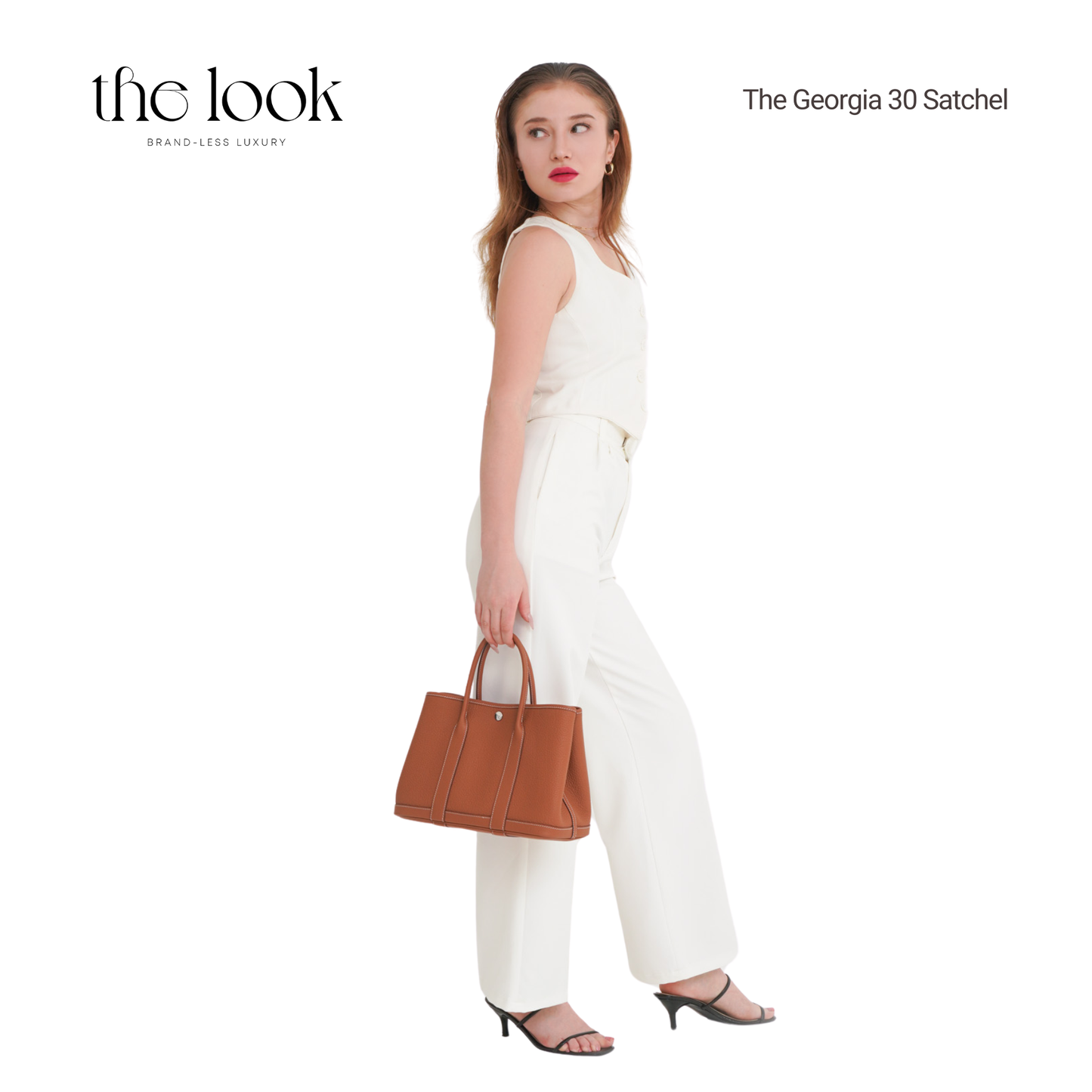 Woman holding a brown handbag with 'the look' branding on a white background | The Look Officiel