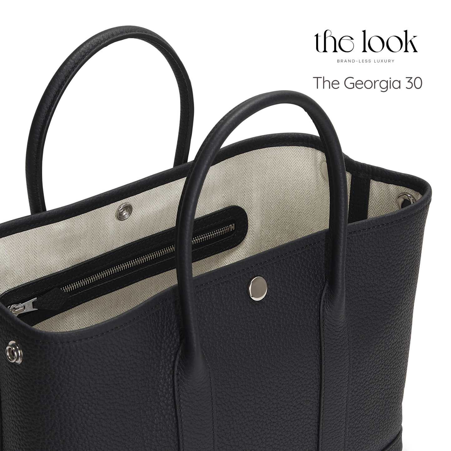 Black handbag with beige interior, featuring 'the look' branding. | The Look Officiel
