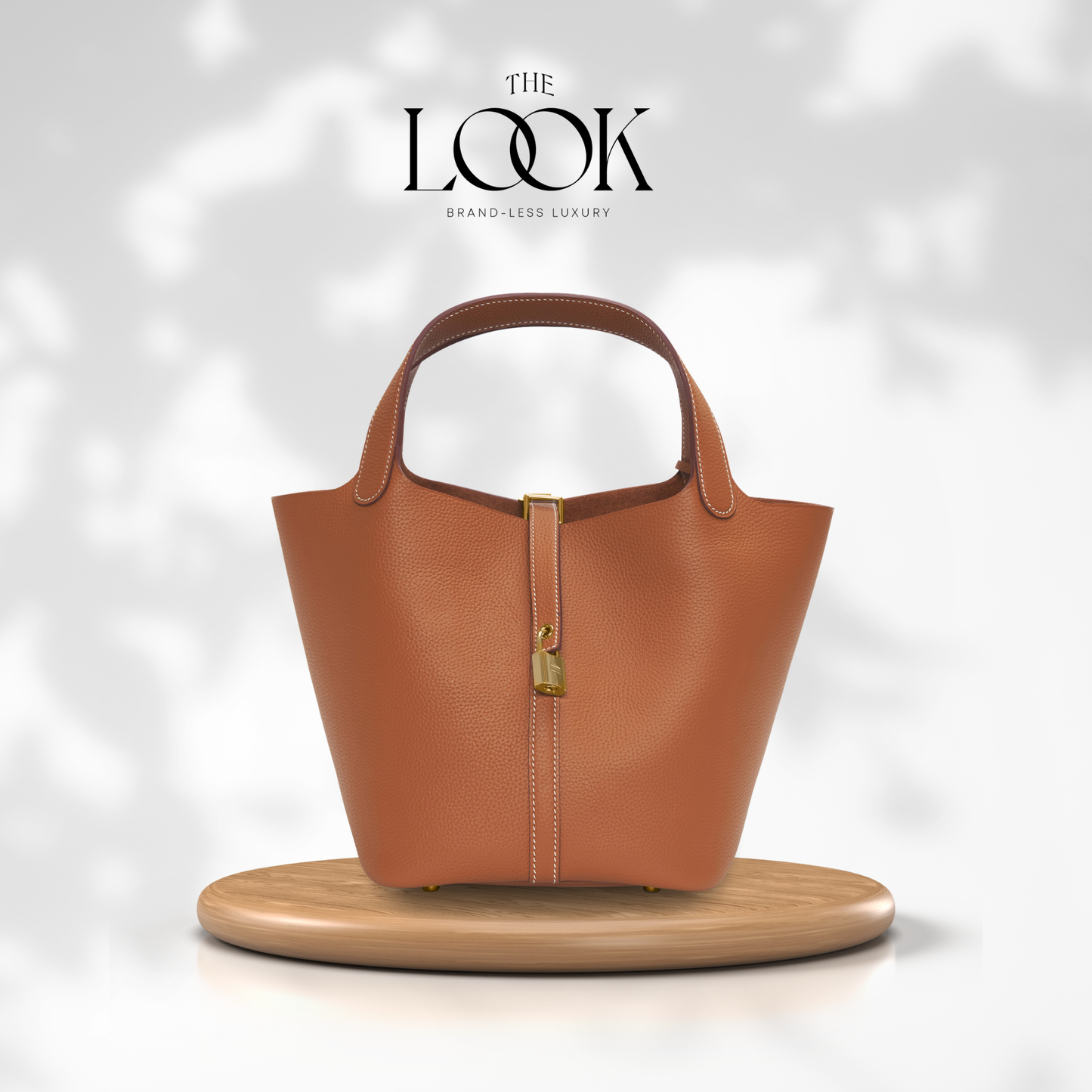 Brown handbag on a wooden stand with 'The Look' branding on a light gray background | The Look Officiel