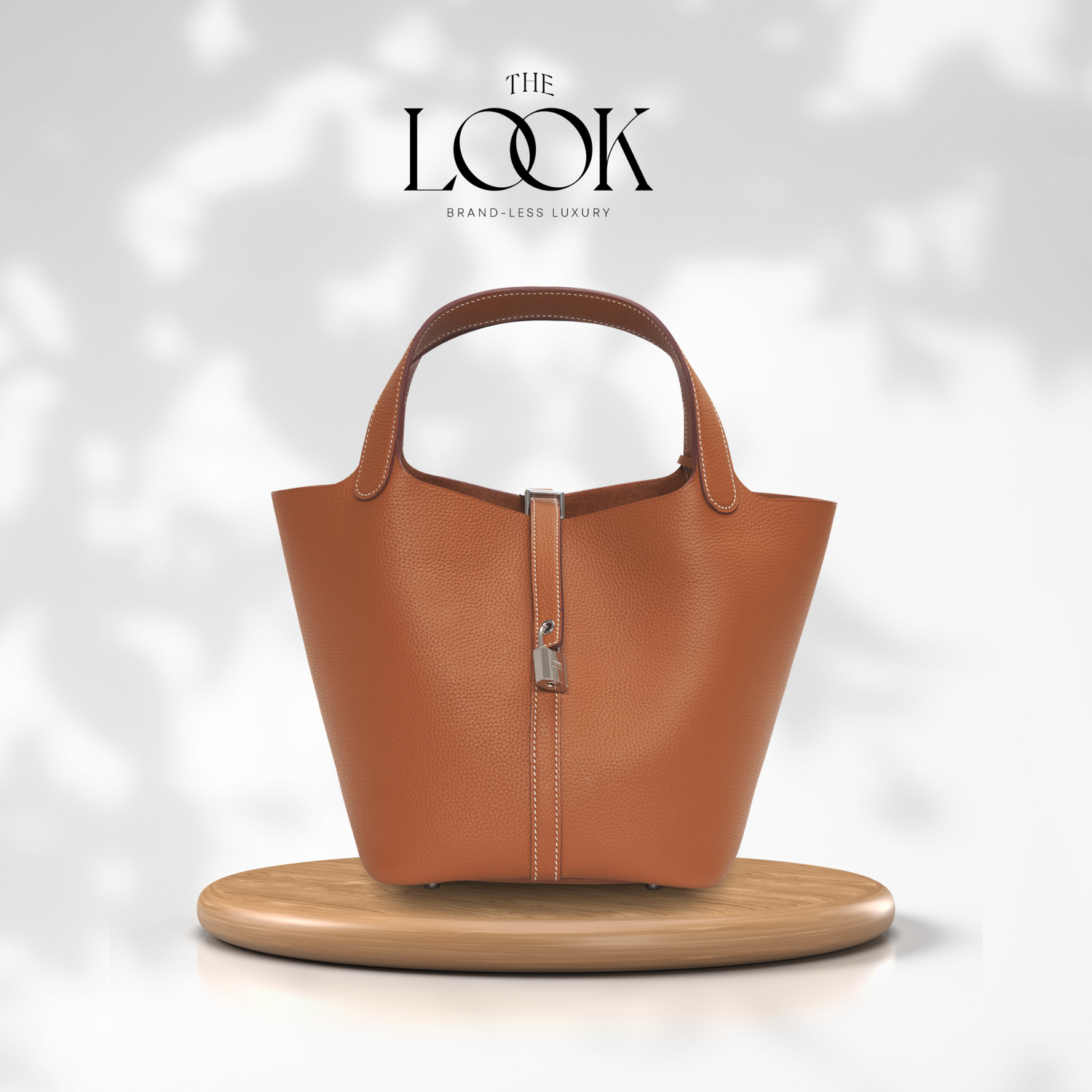 Brown leather handbag on a wooden stand with 'The Look' branding. | The Look Officiel