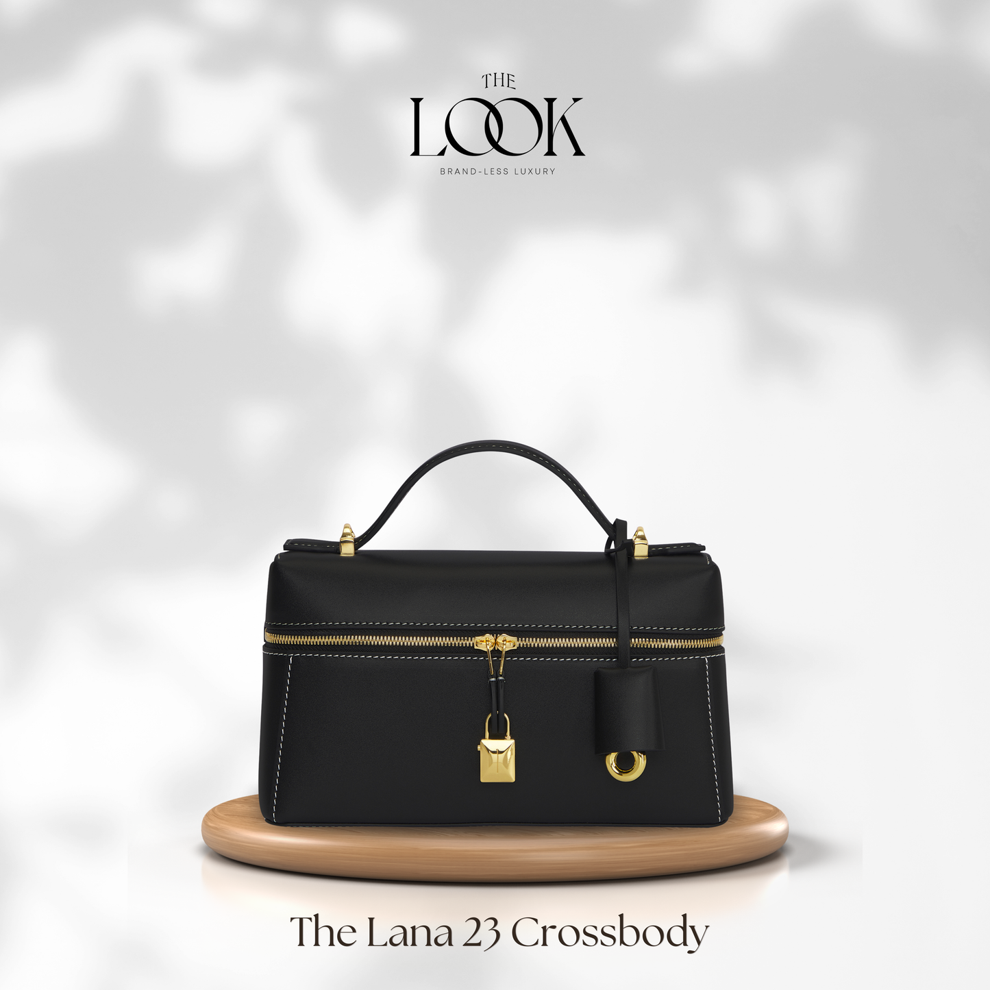 Black crossbody bag with gold accents on a white background, featuring 'The Look' brand. | The Look Officiel
