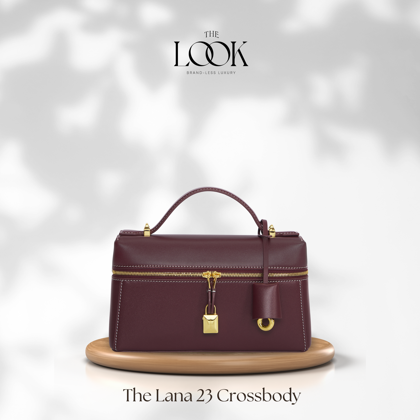 Maroon crossbody bag with gold accents on a white background, featuring 'The Look' brand. | The Look Officiel