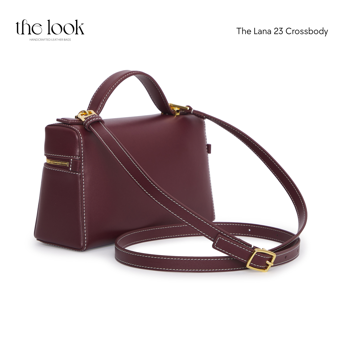 Maroon crossbody bag with gold accents on a white background | The Look Officiel