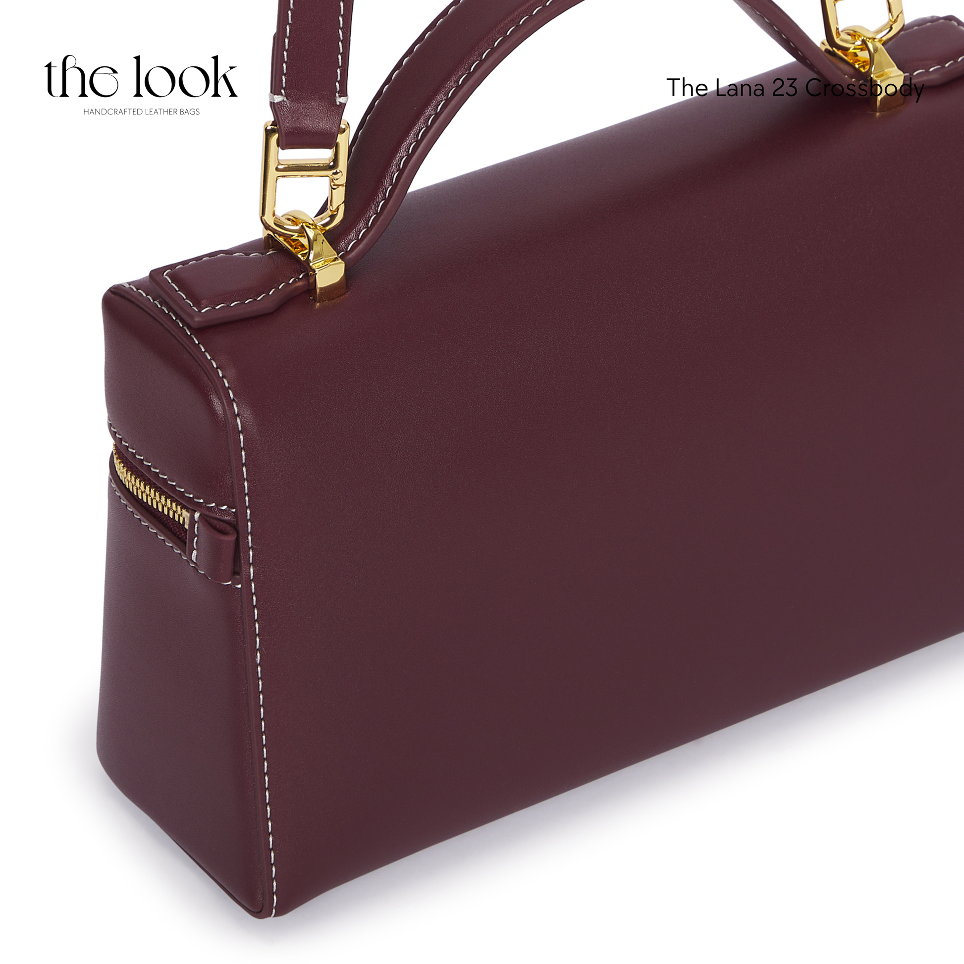 Maroon handbag with gold accents on a white background | The Look Officiel