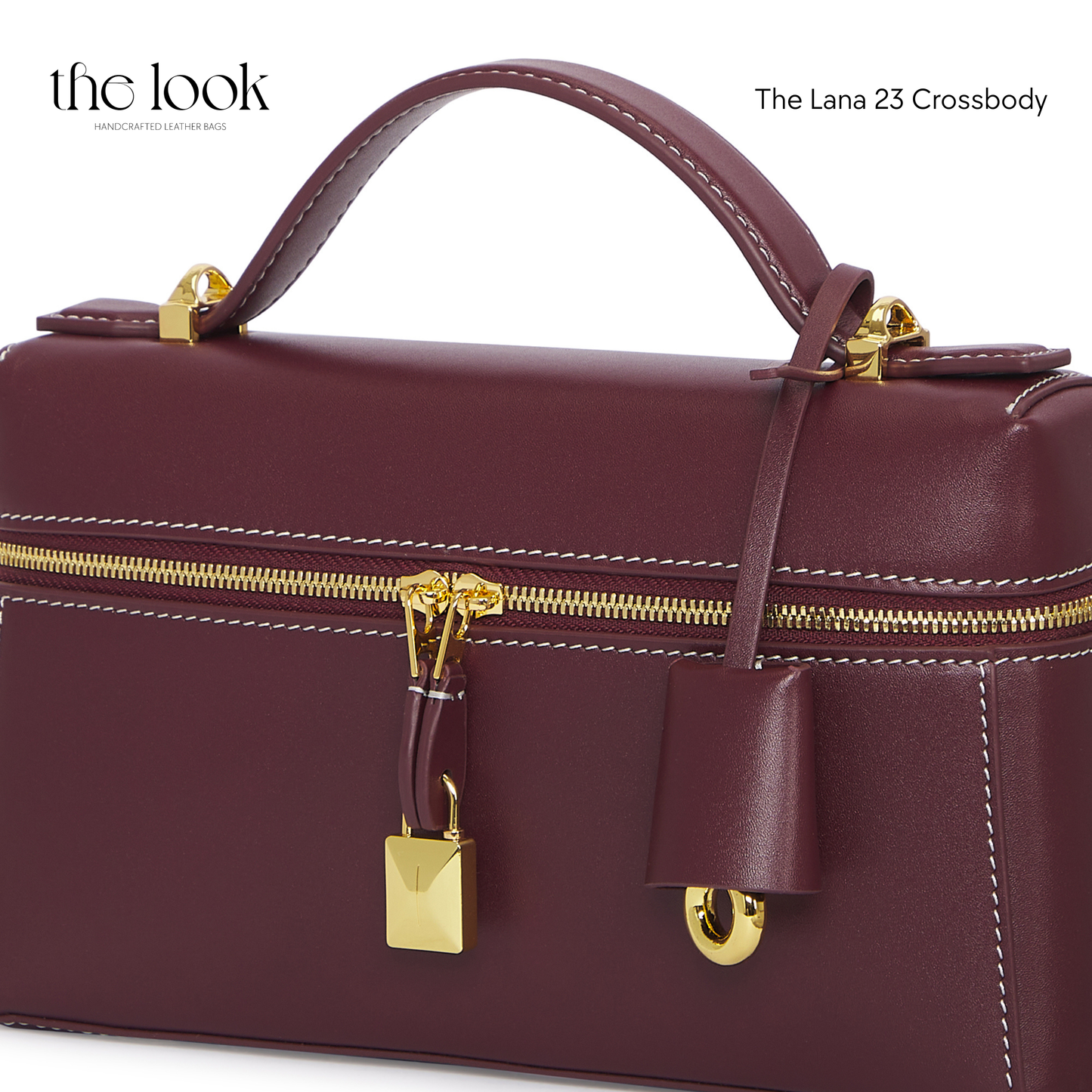 Maroon handbag with gold accents on a white background, featuring 'the look' brand. | The Look Officiel