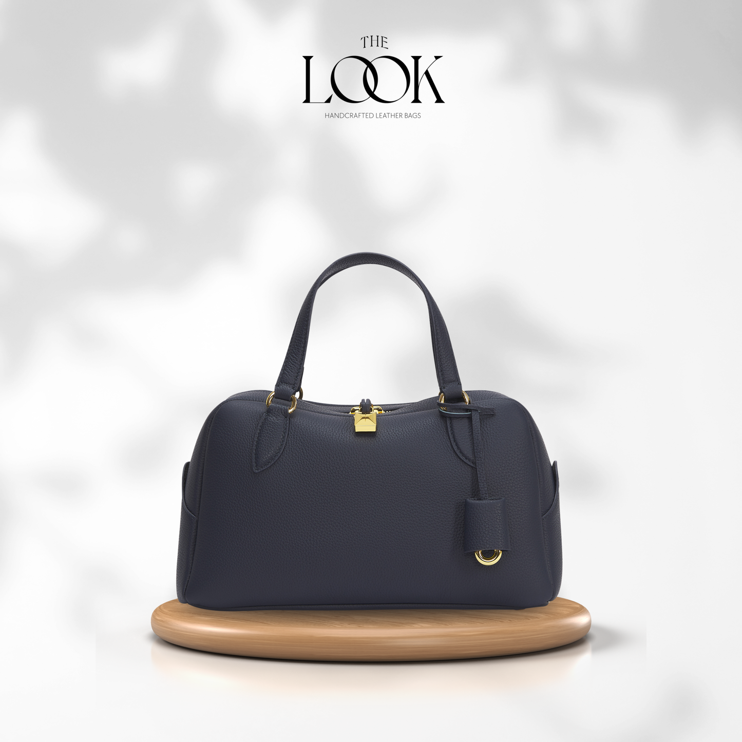 Navy blue handbag on a wooden stand with 'The Look' branding. | The Look Officiel