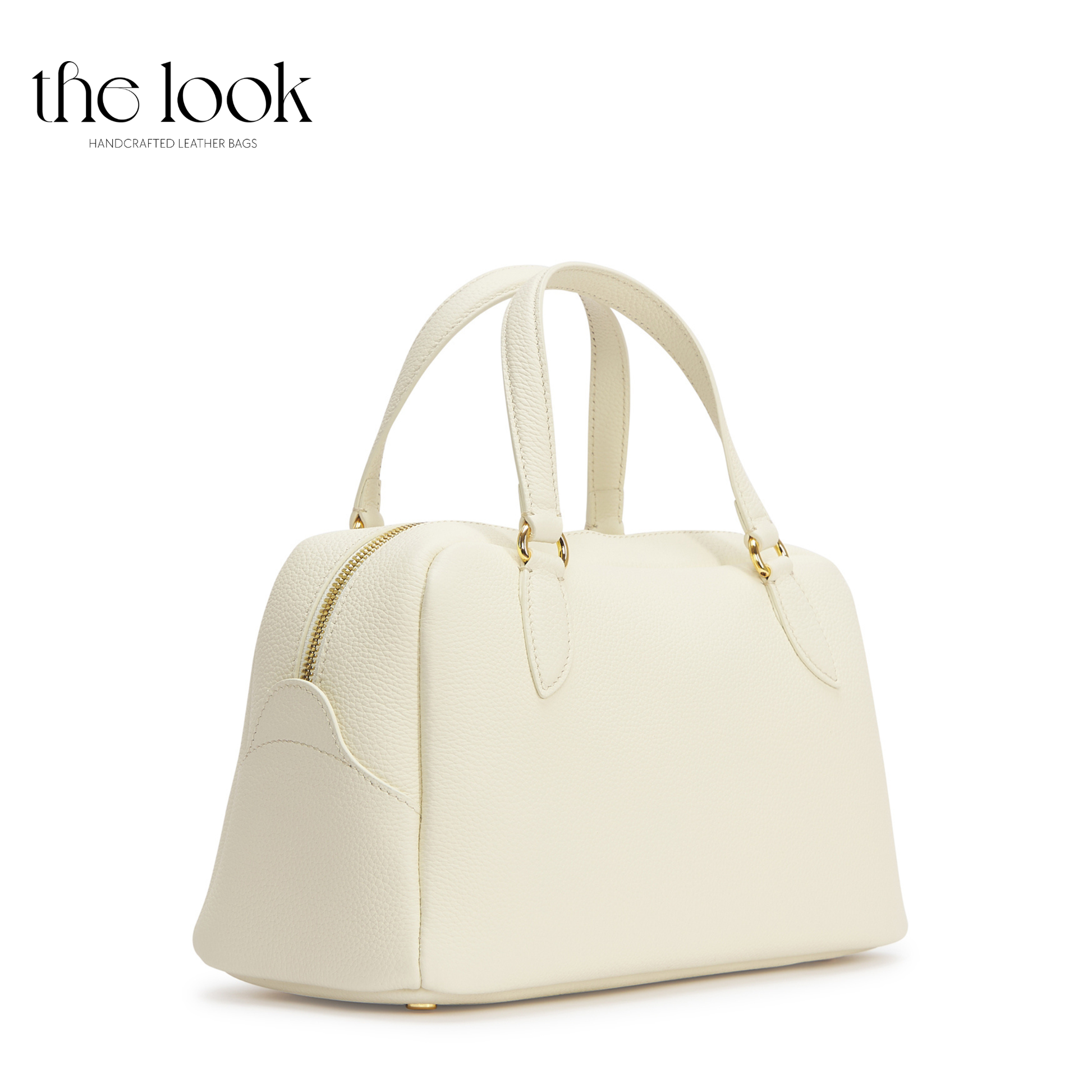 White handbag with gold accents on a white background, branded 'the look'. | The Look Officiel