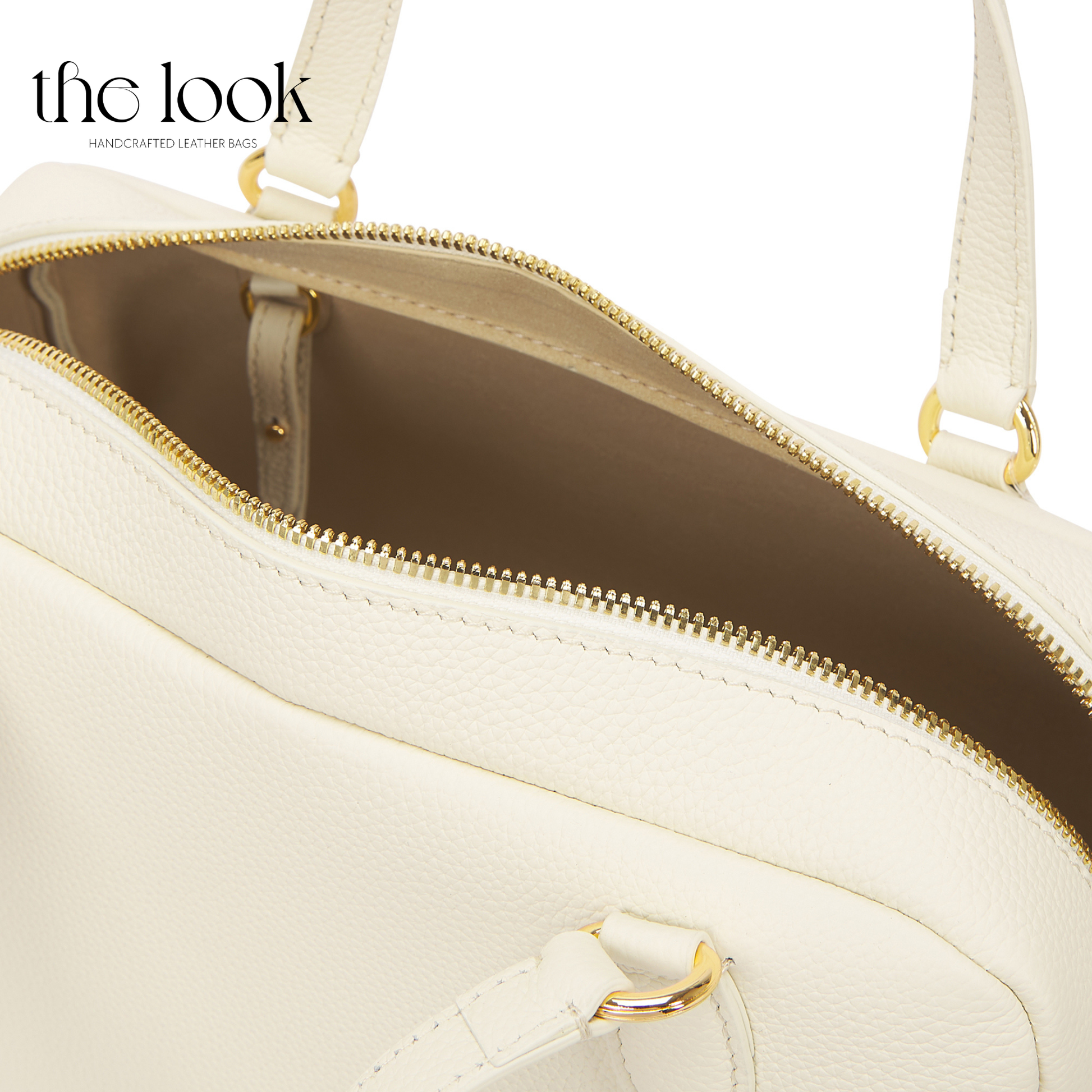 White handbag with gold accents on a white background, featuring 'the look' brand. | The Look Officiel