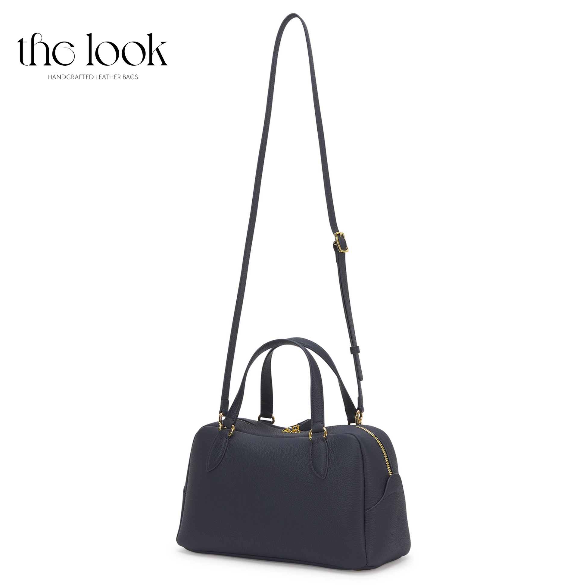 Navy handbag with a strap on a white background, branded 'the look'. | The Look Officiel