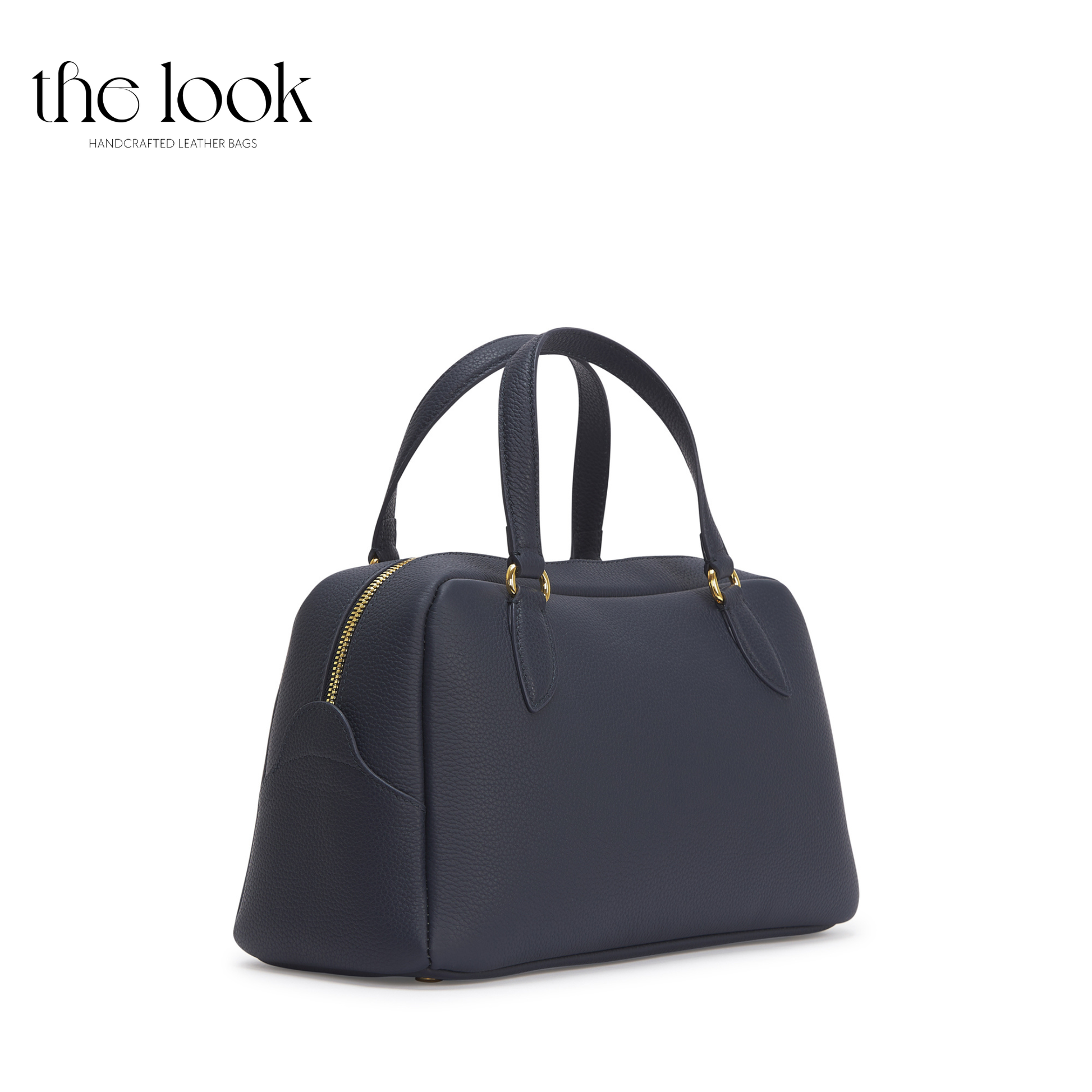 Navy blue handbag with gold zippers on a white background, branded 'the look'. | The Look Officiel