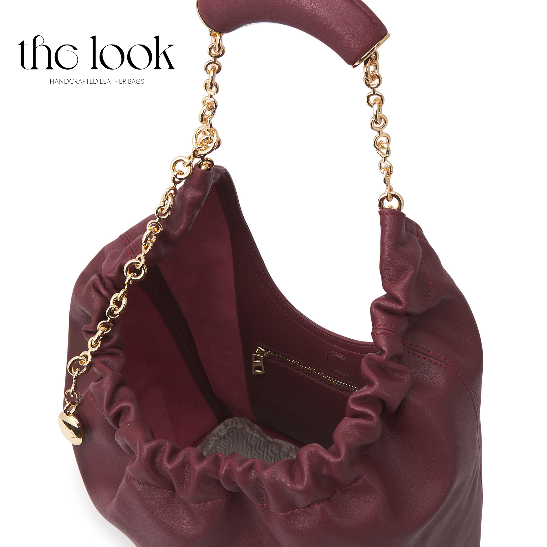 Maroon handbag with gold chain handle on a white background, branded 'the look'. | The Look Officiel