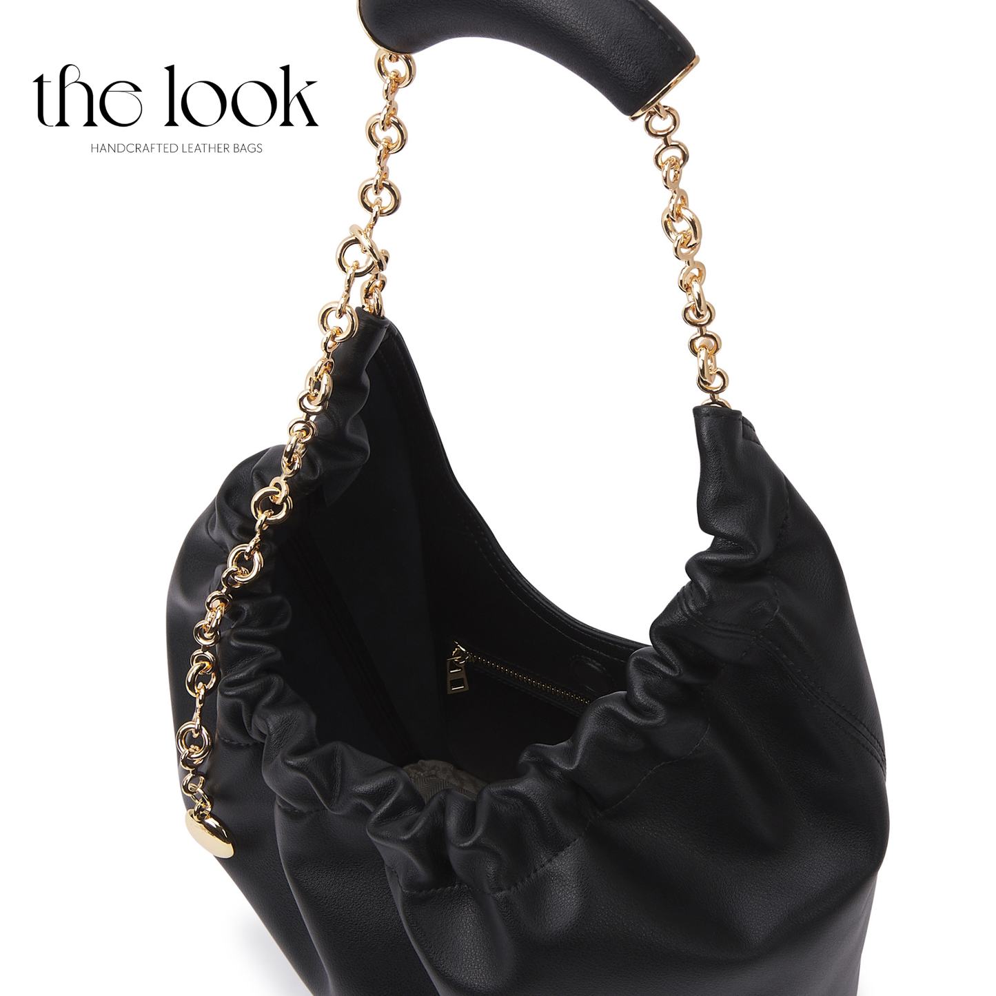Black handbag with ruffled details and gold chain handle on a white background, branded 'the look'. | The Look Officiel