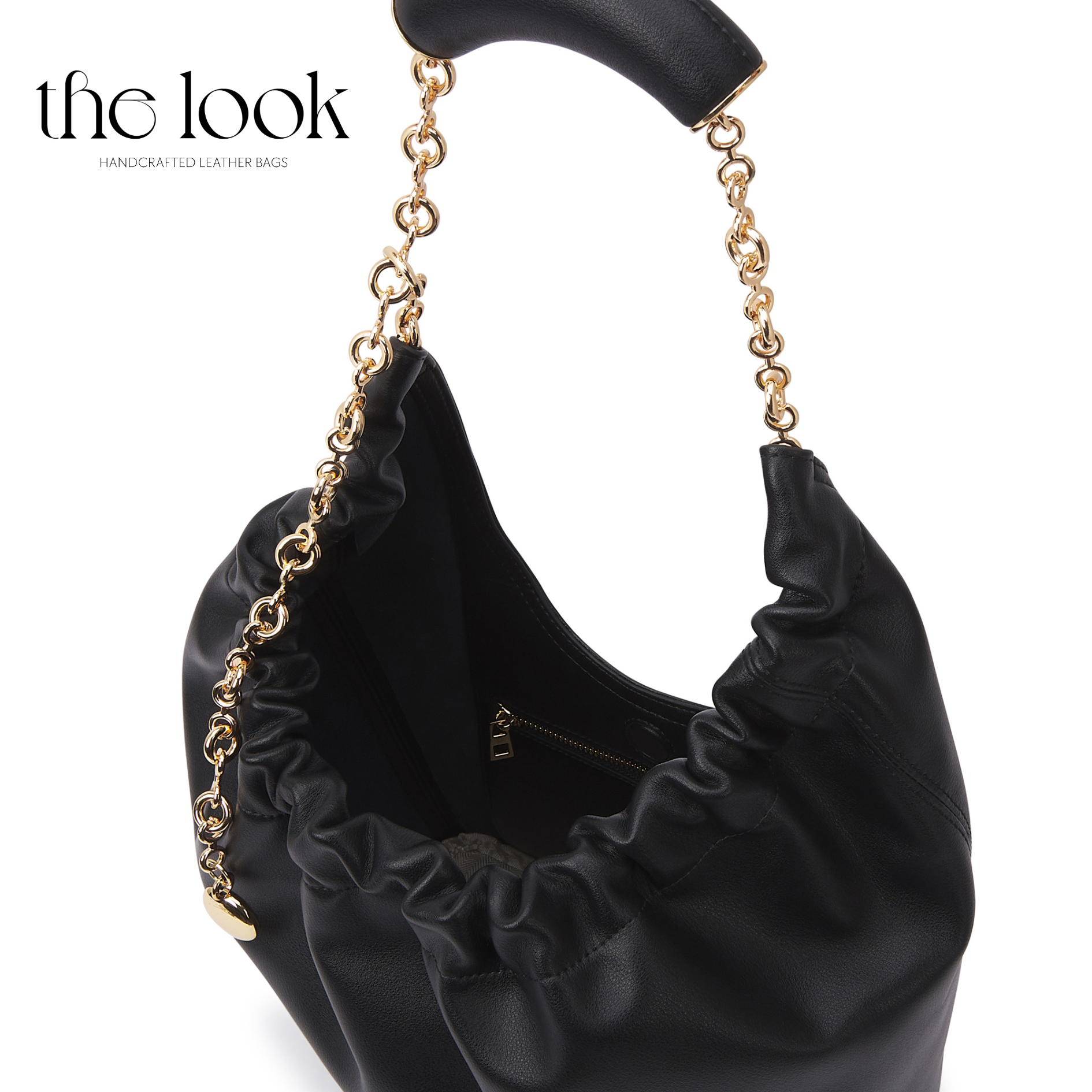 Black handbag with ruffled details and gold chain handle on a white background, branded 'the look'. | The Look Officiel