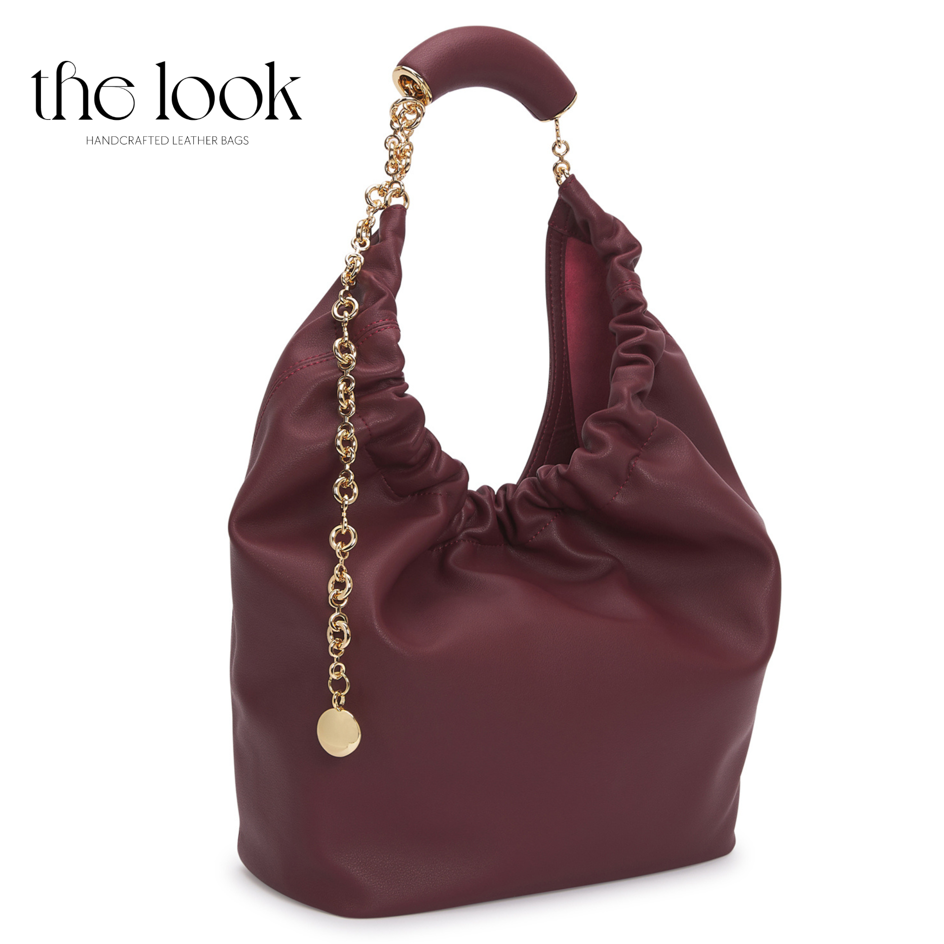 Maroon handbag with gold chain and accents on a white background, branded 'the look'. | The Look Officiel