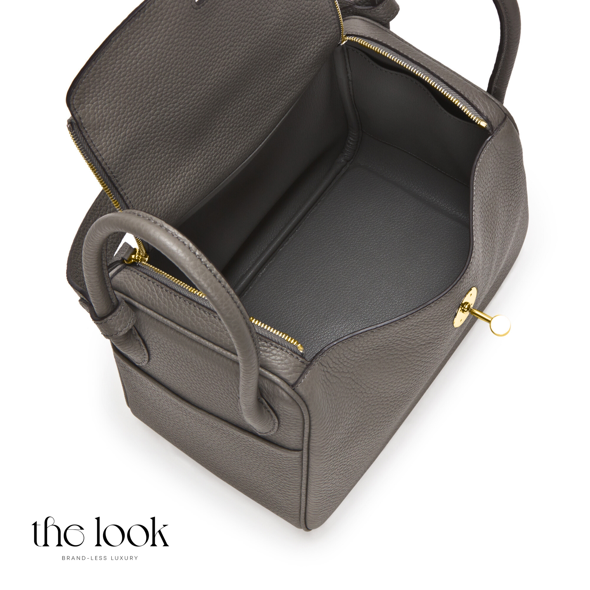 Gray leather bag with gold zipper on a white background | The Look Officiel
