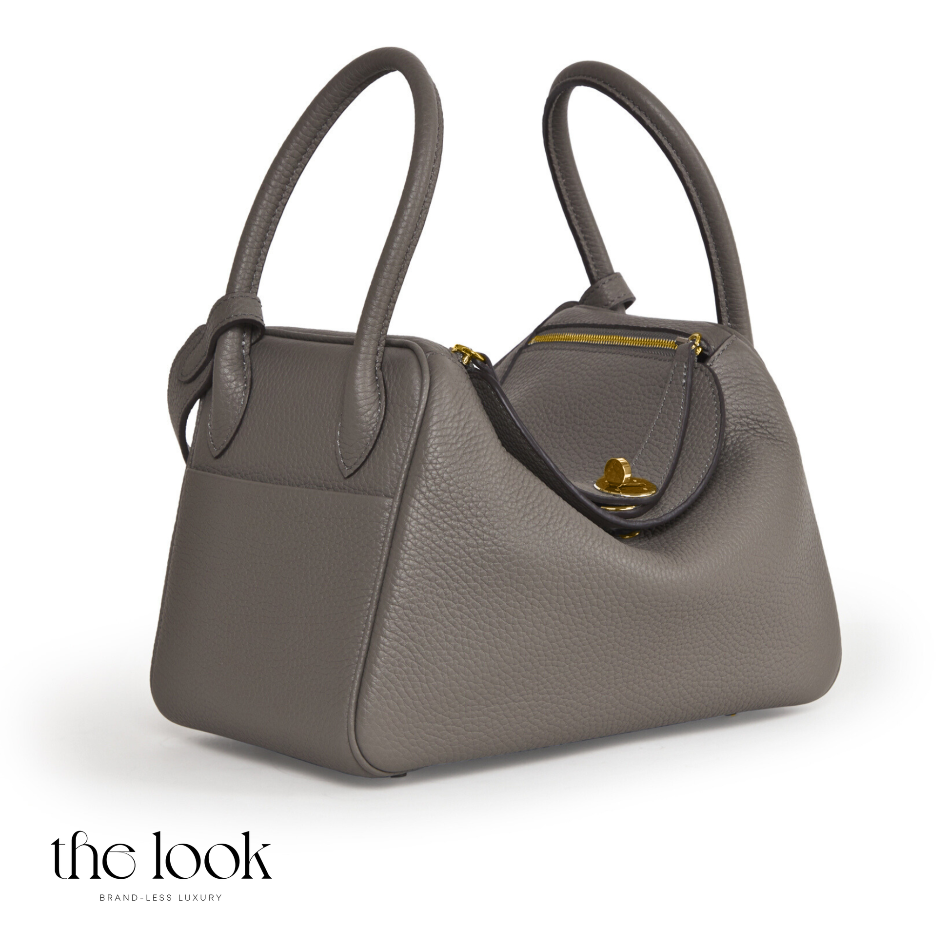 Gray handbag with gold zipper on a white background, branded 'the look'. | The Look Officiel