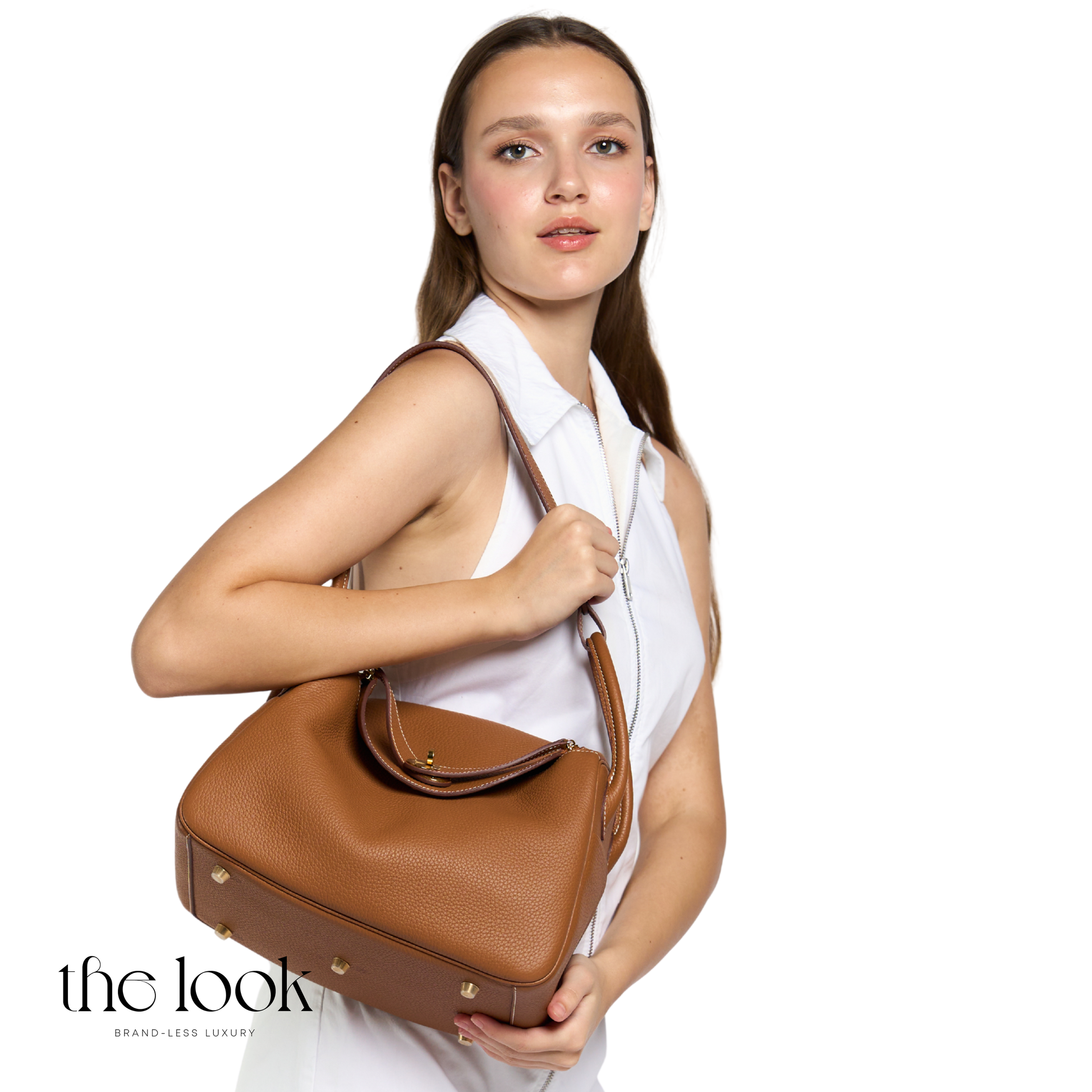 Woman holding a brown handbag against a white background with 'the look' branding. | The Look Officiel