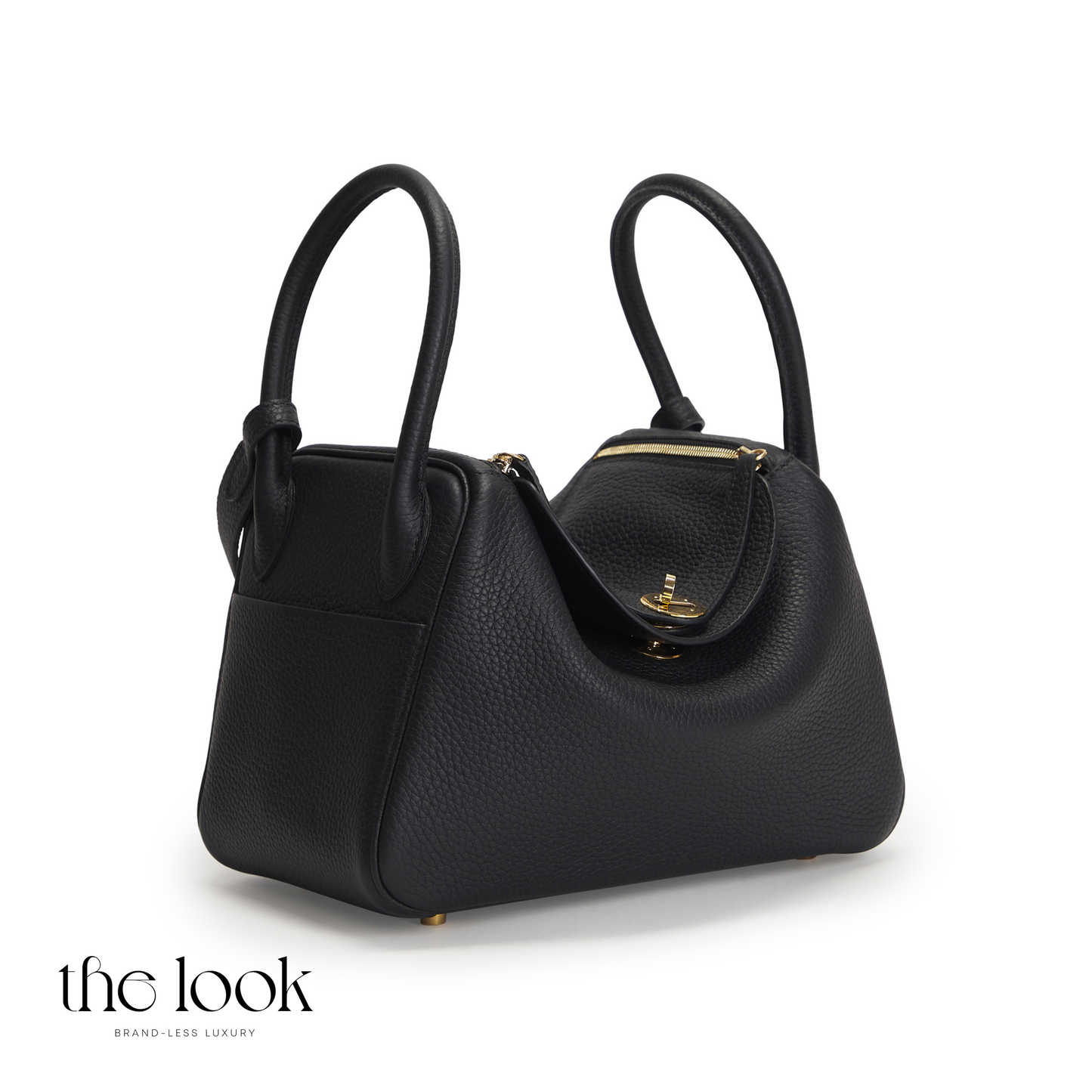 Black handbag with gold accents on a white background, featuring 'the look' brand. | The Look Officiel